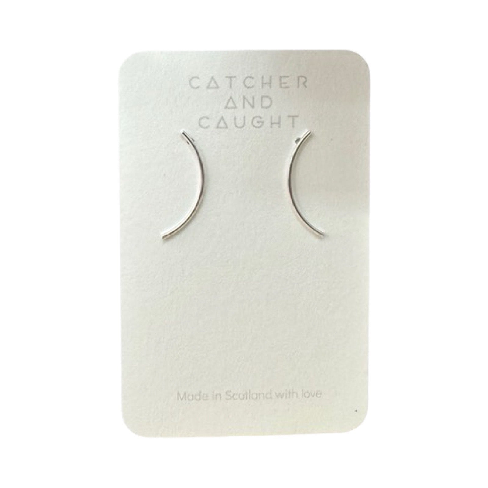 Curve stud earrings packaged.