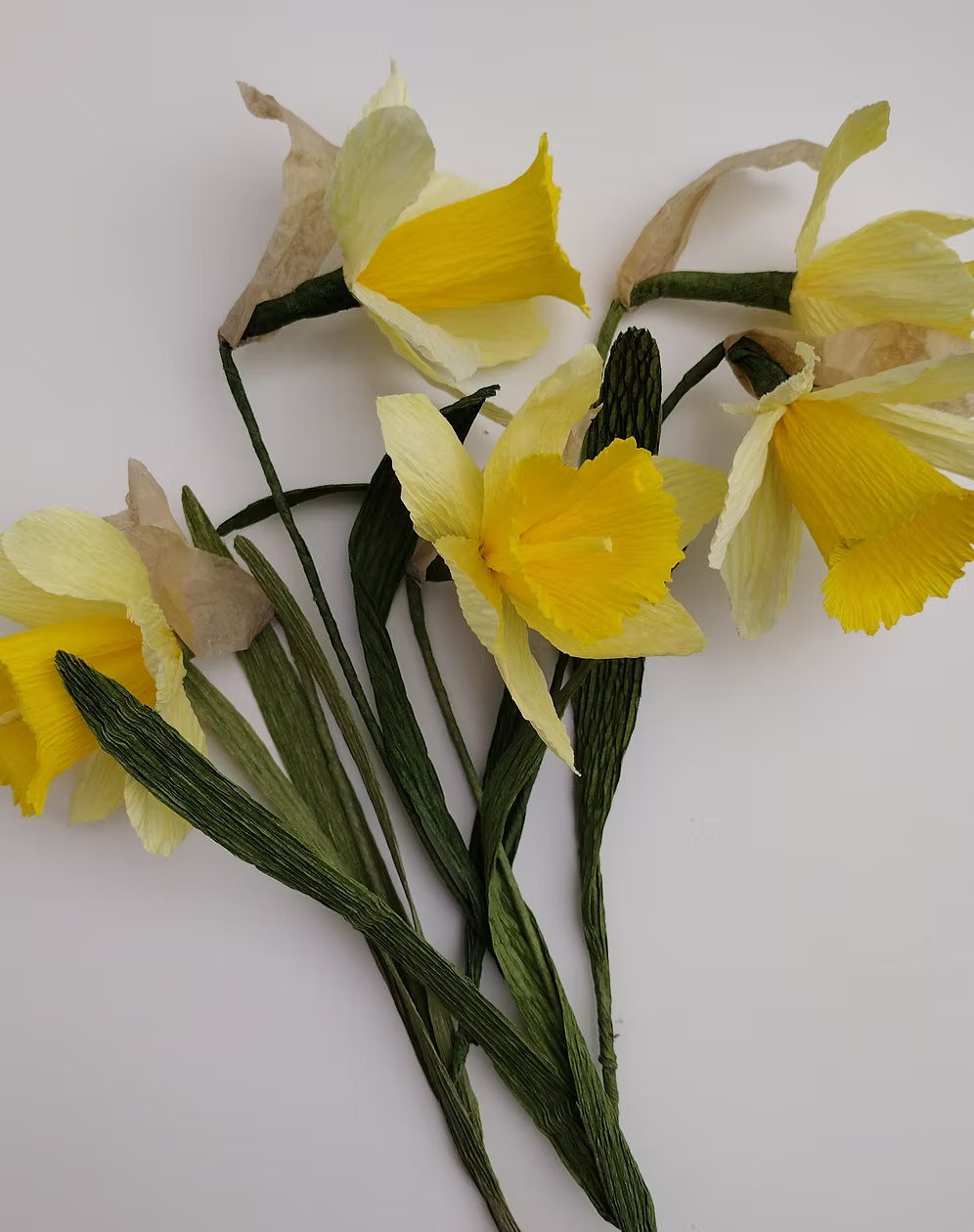 Yellow artificial flowers on a white background.