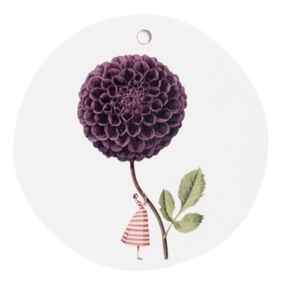 Decorative gift tag with a purple flower and small figure on a white background.