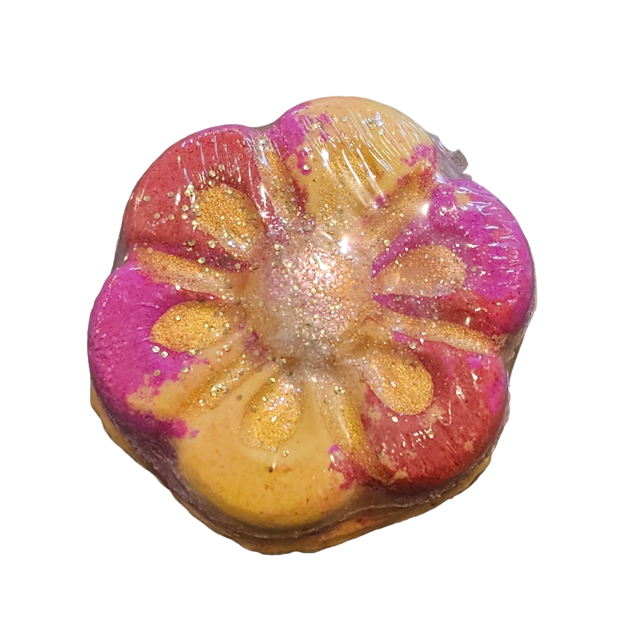 A pink and orange daisy-shaped bath bomb.