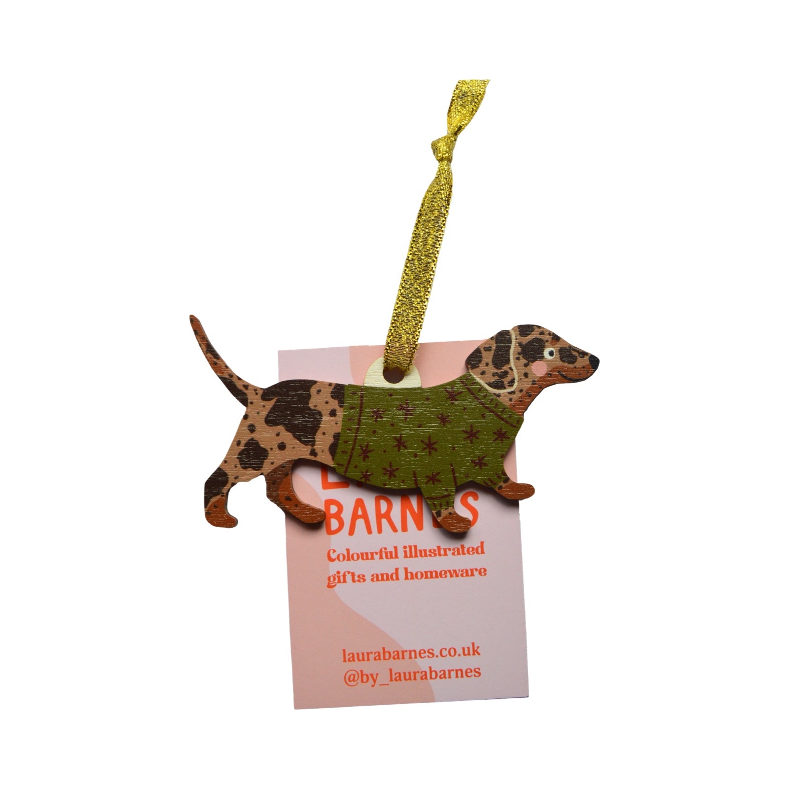 Dog-shaped ornament with a green sweater on a white background.