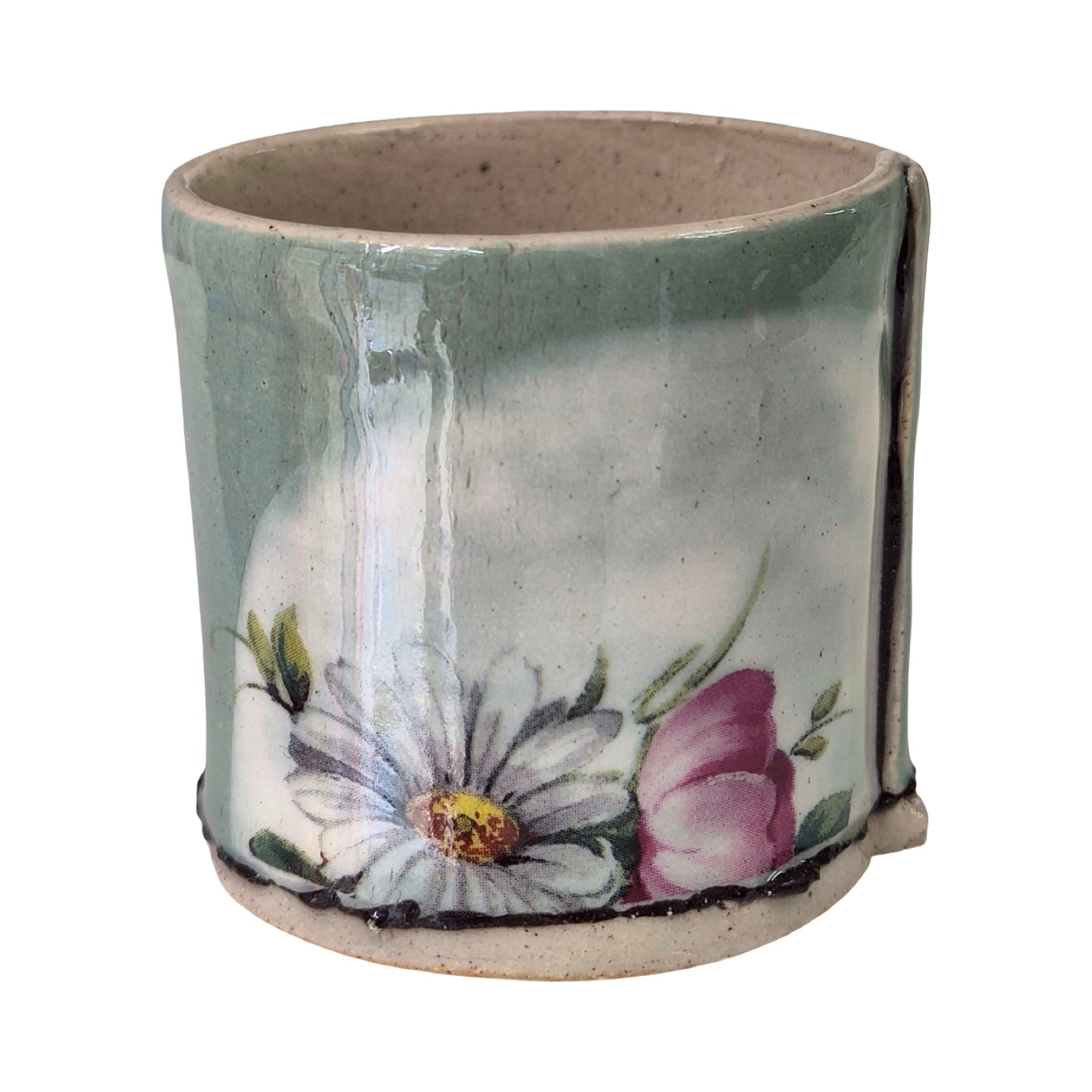 Ceramic green planter with floral design on a white background.