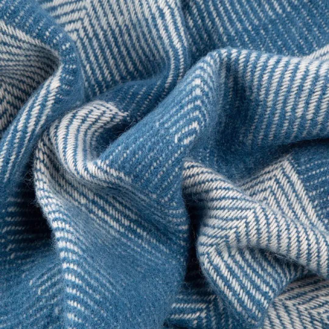 This blue and grey, diamond patterned, cosy and fluffy blanket is made from 100% pure new wool and finished with extra brushing to make it exceptionally soft.