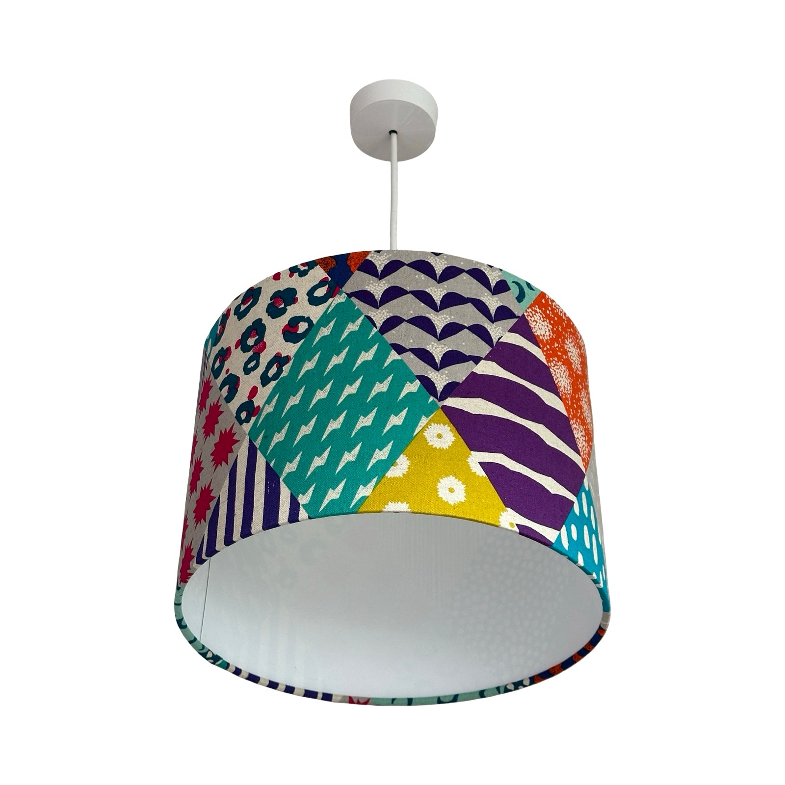 Colourful patterned lampshade on a white background.