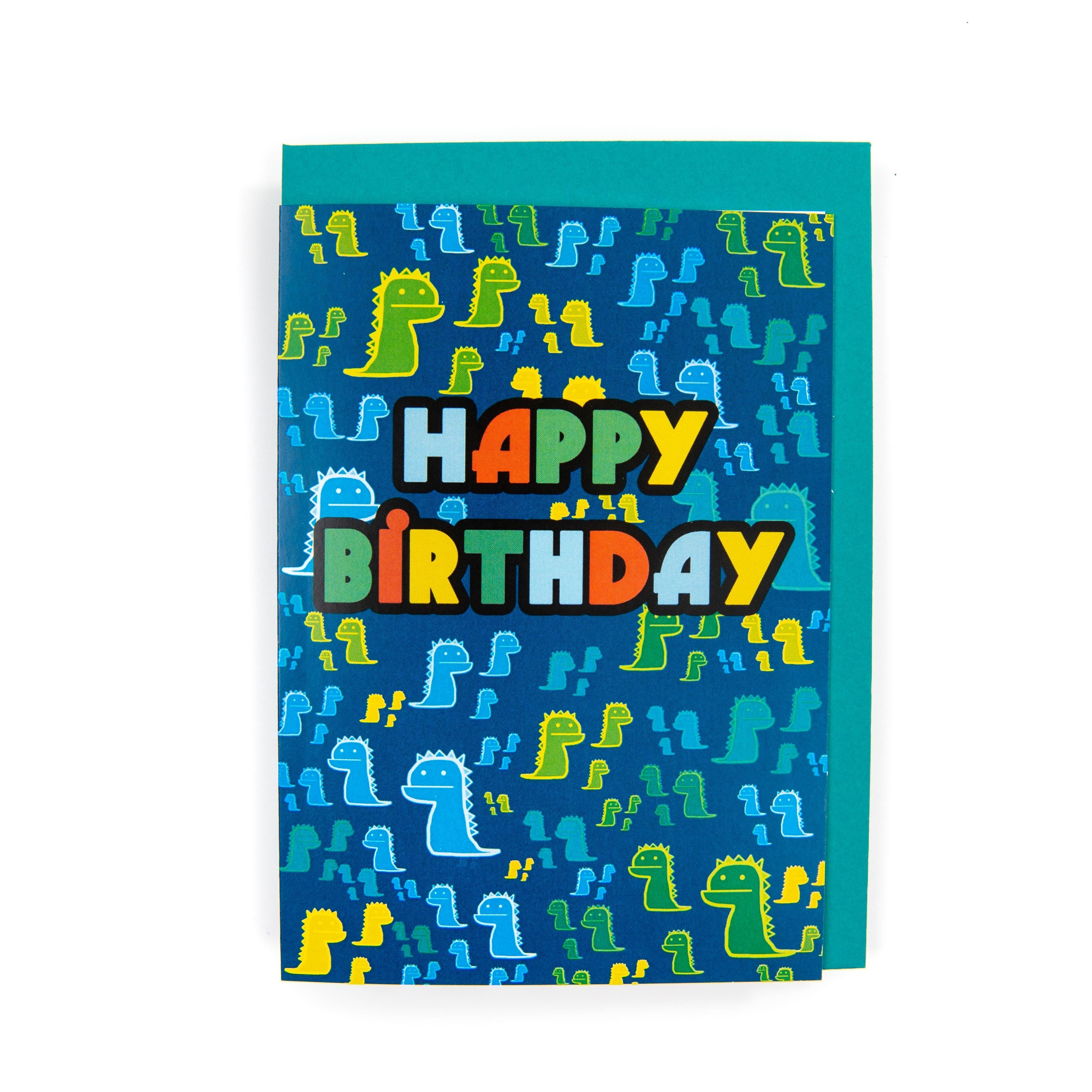 A colorful dinosaur birthday card with the text 'Happy Birthday', featuring illustrations of various dinosaurs on a blue background, and an envelope included.