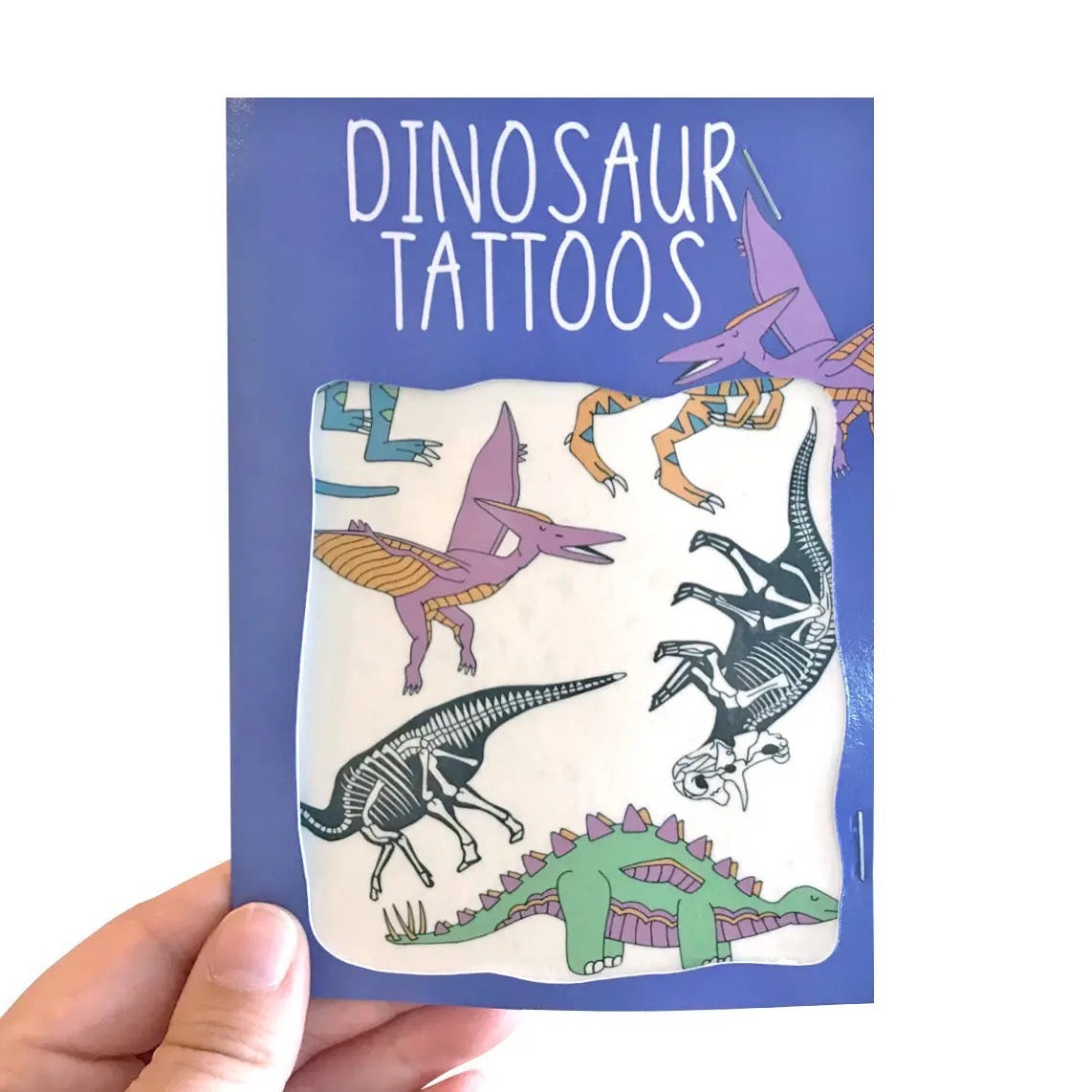 Pack of dinosaur tattoos held by a hand with a blue background.