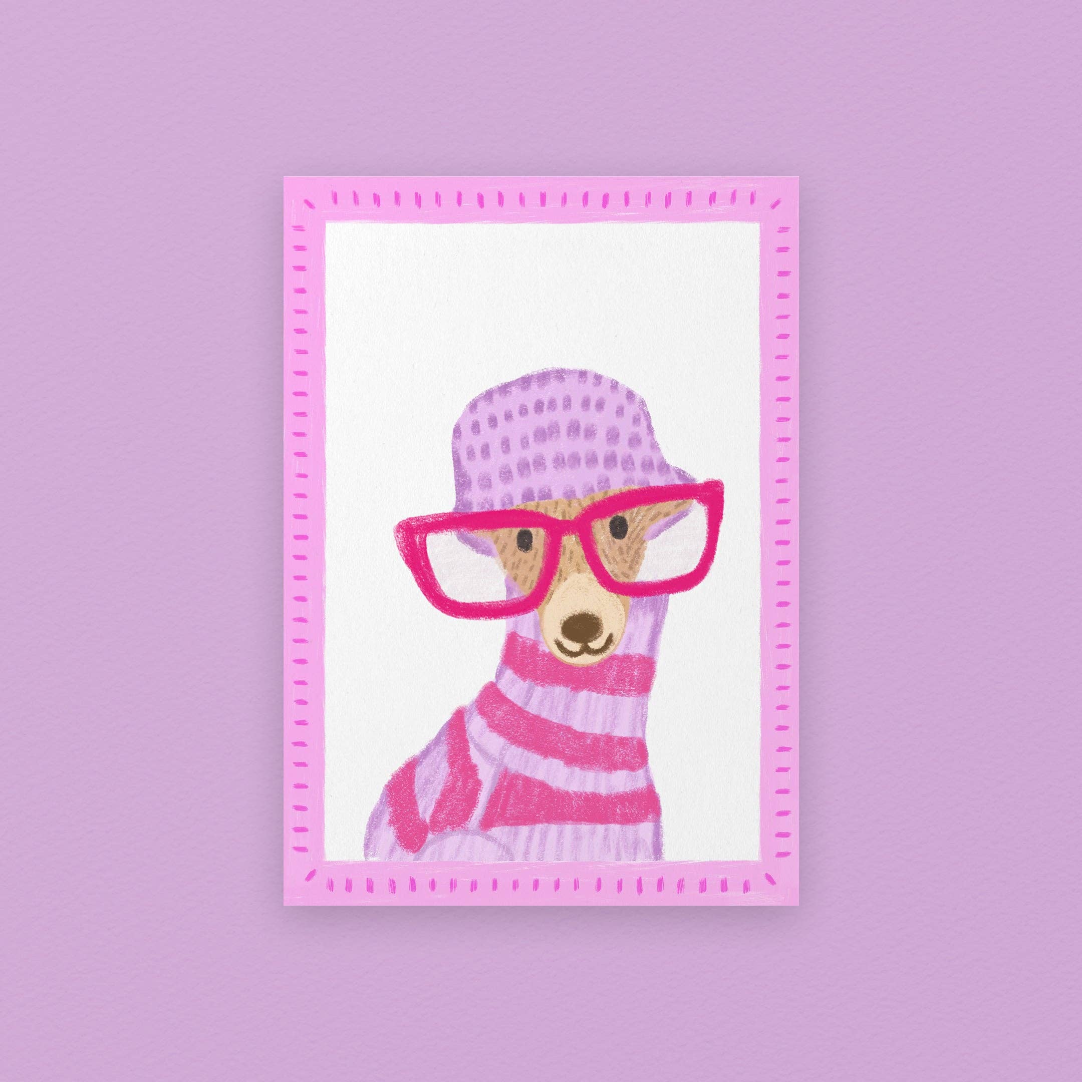 Framed artwork of a dog wearing pink glasses and a striped sweater on a purple background.