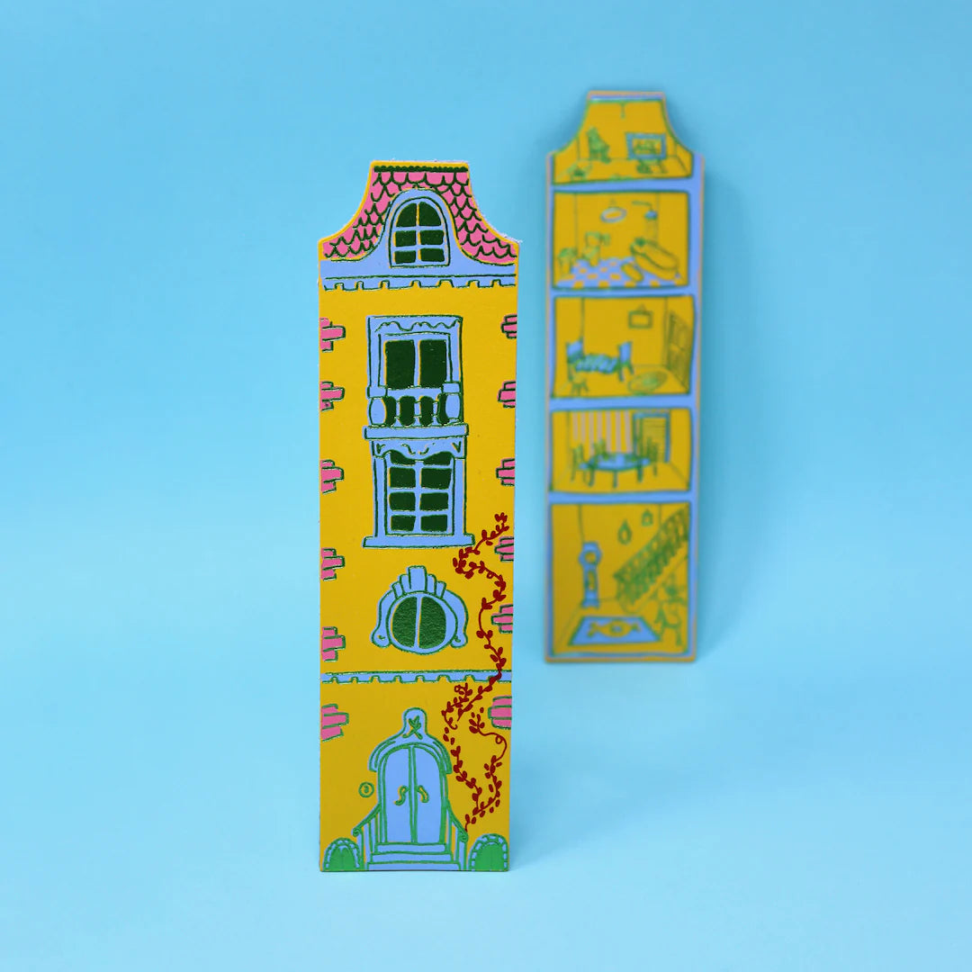 Decorative yellow dolls house with colourful designs on a blue background.