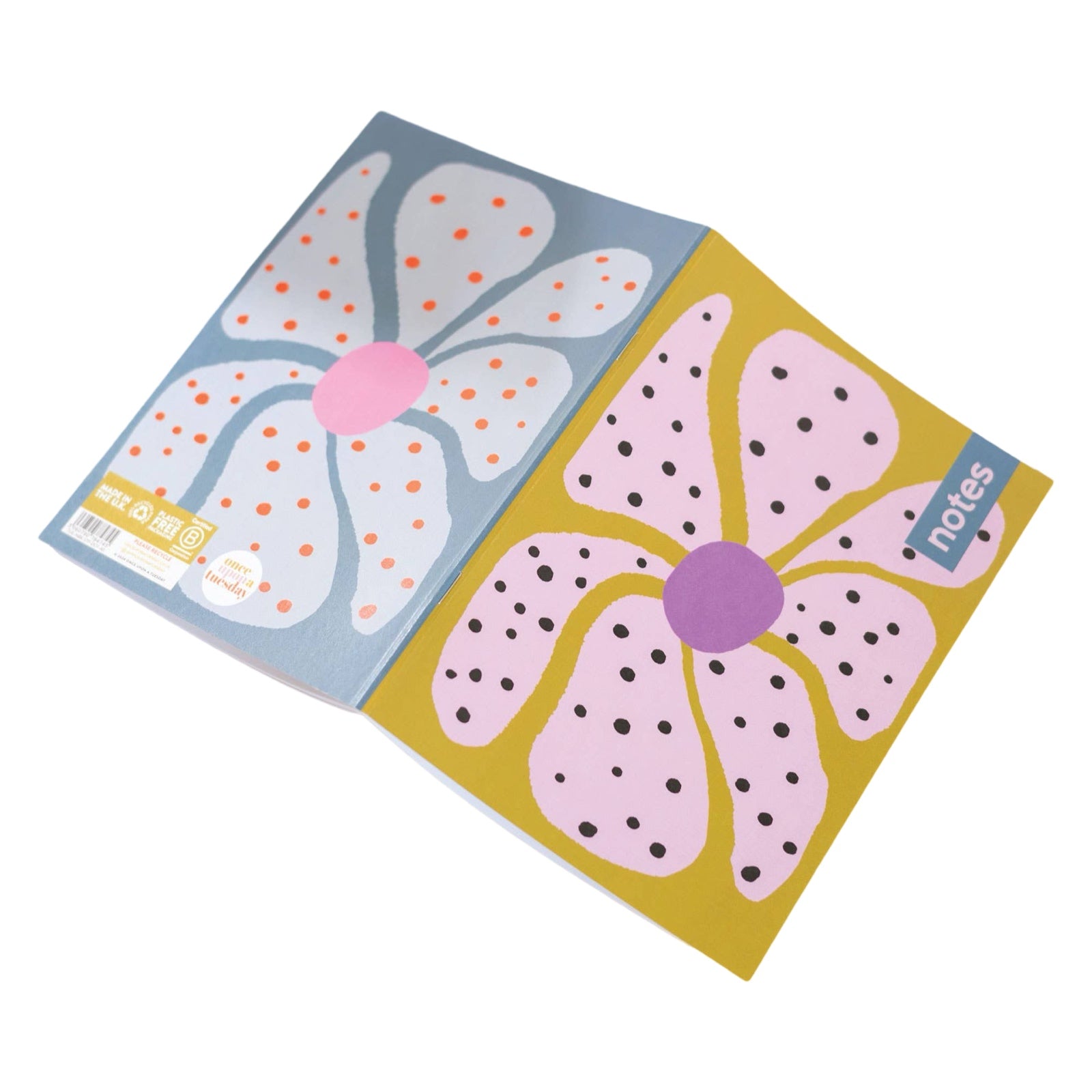 An abstract floral notebook with a giant pink spotty fleur on the front cover and blue on the back.