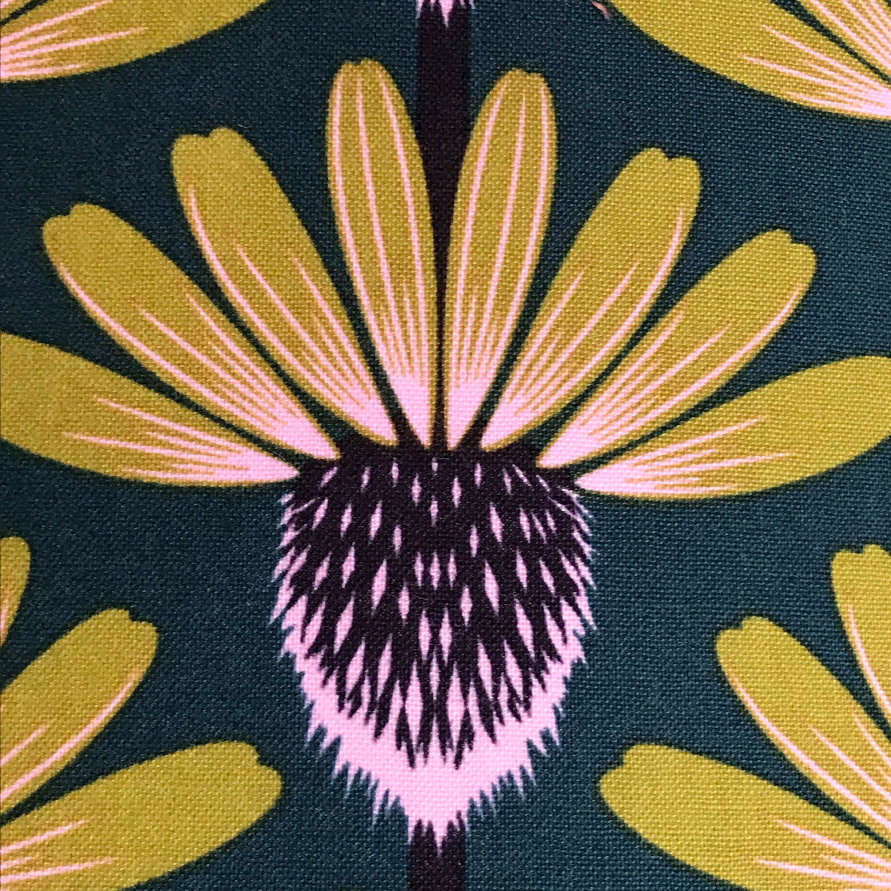 Fabric with mustard and purple echinacea flowers on a navy background