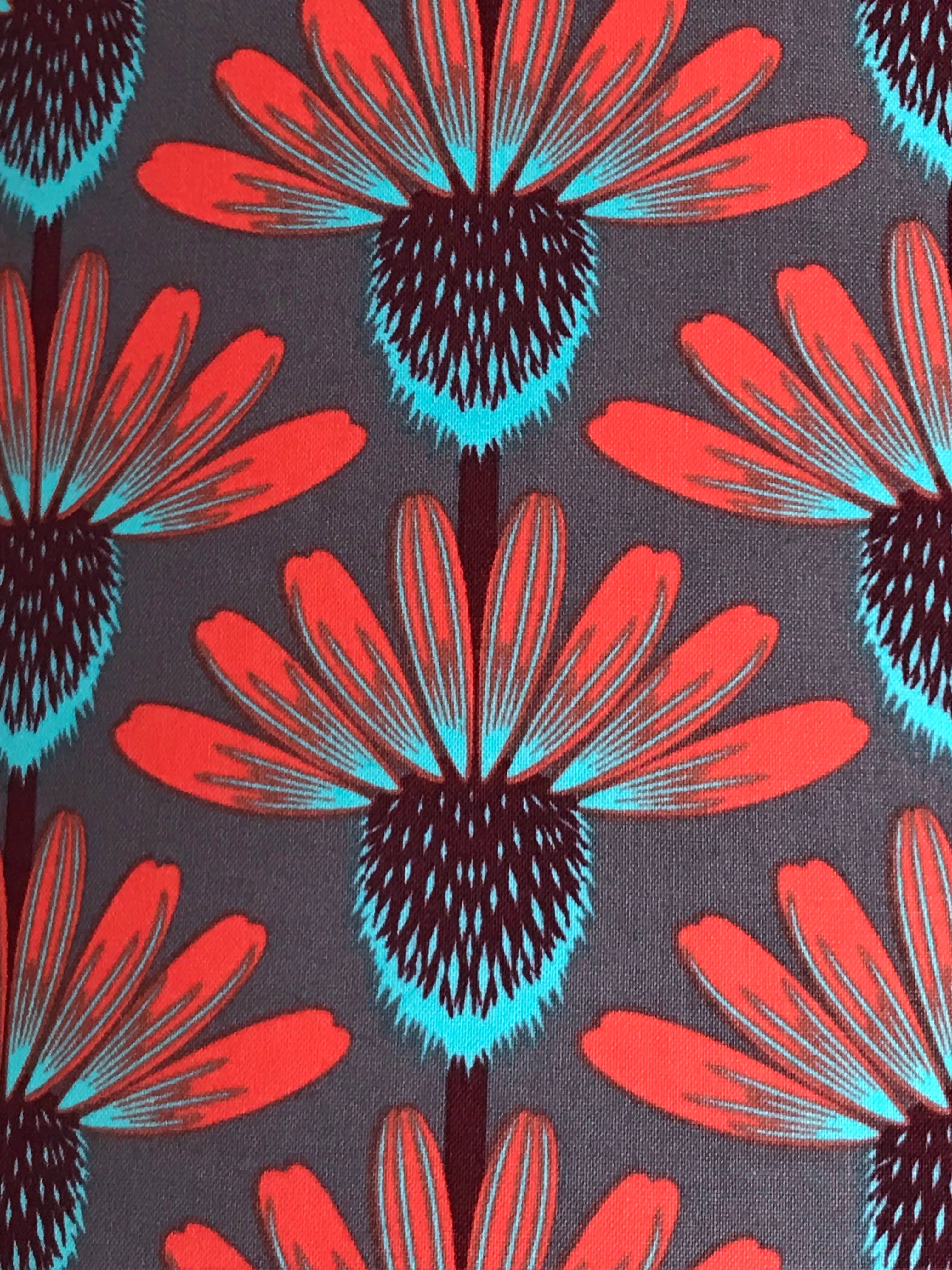 Grey fabric with red, brown and blue echinacea flowers