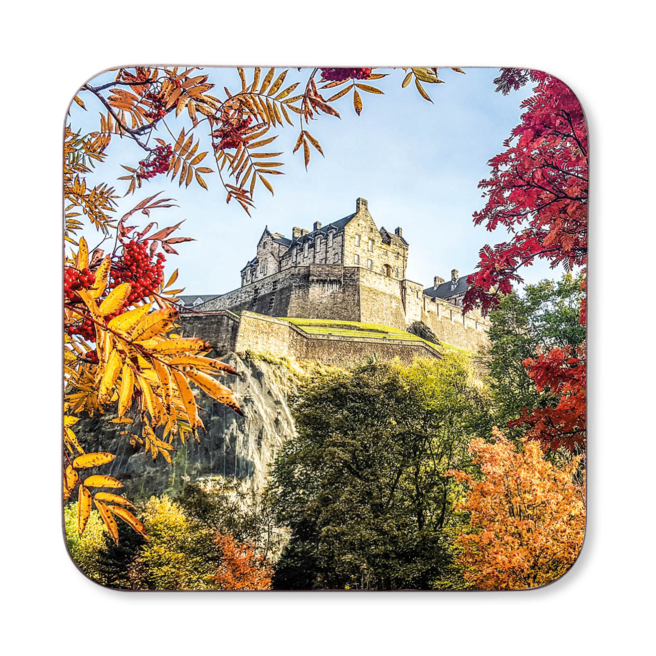 Coaster with a scenic design of a castle surrounded by autumn foliage