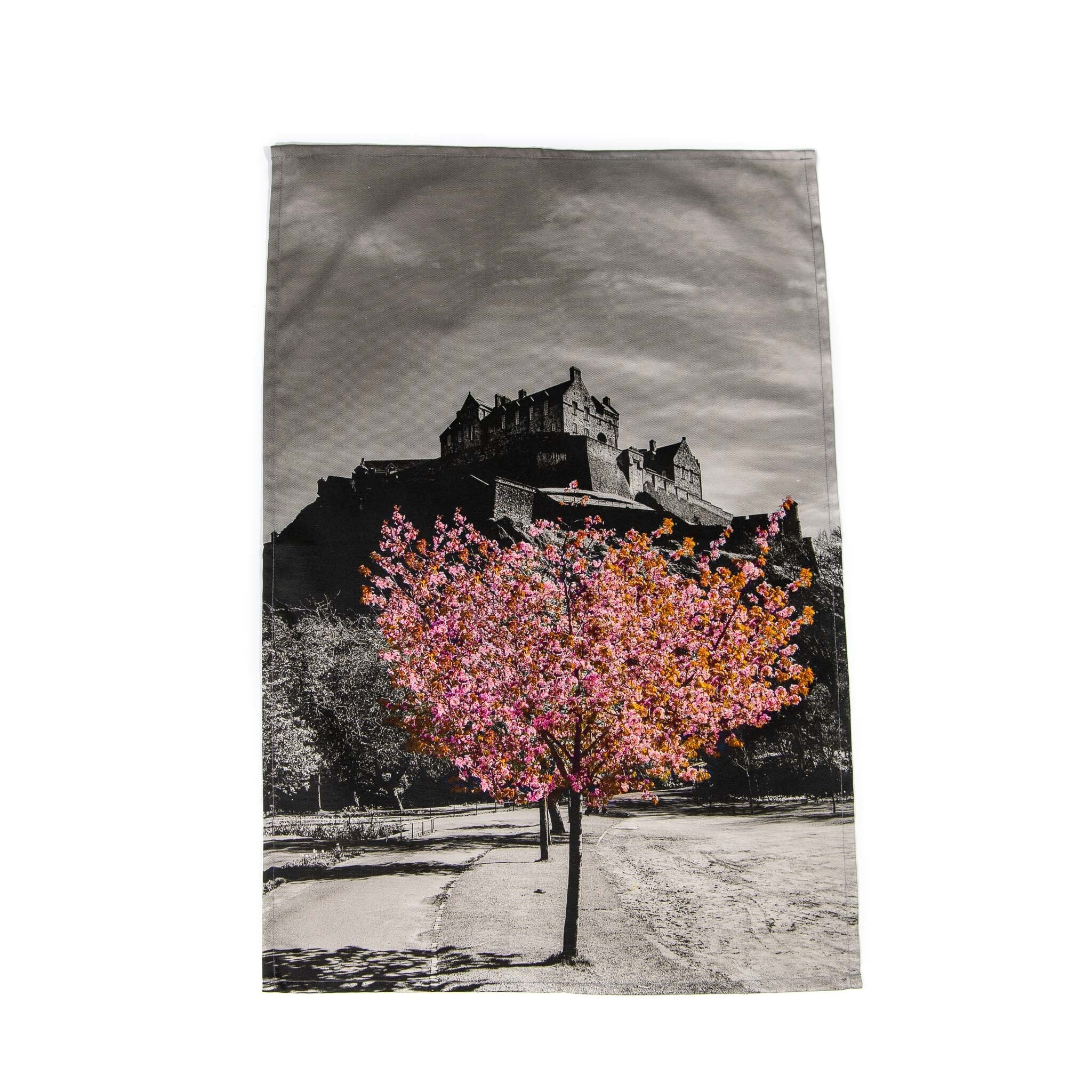 An image of Edinburgh Castle and a cherry tree in blossom on a tea towel.