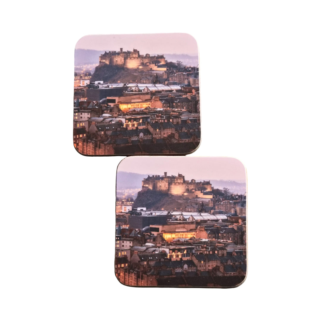 Two coasters with a cityscape design featuring a illuminated castle.