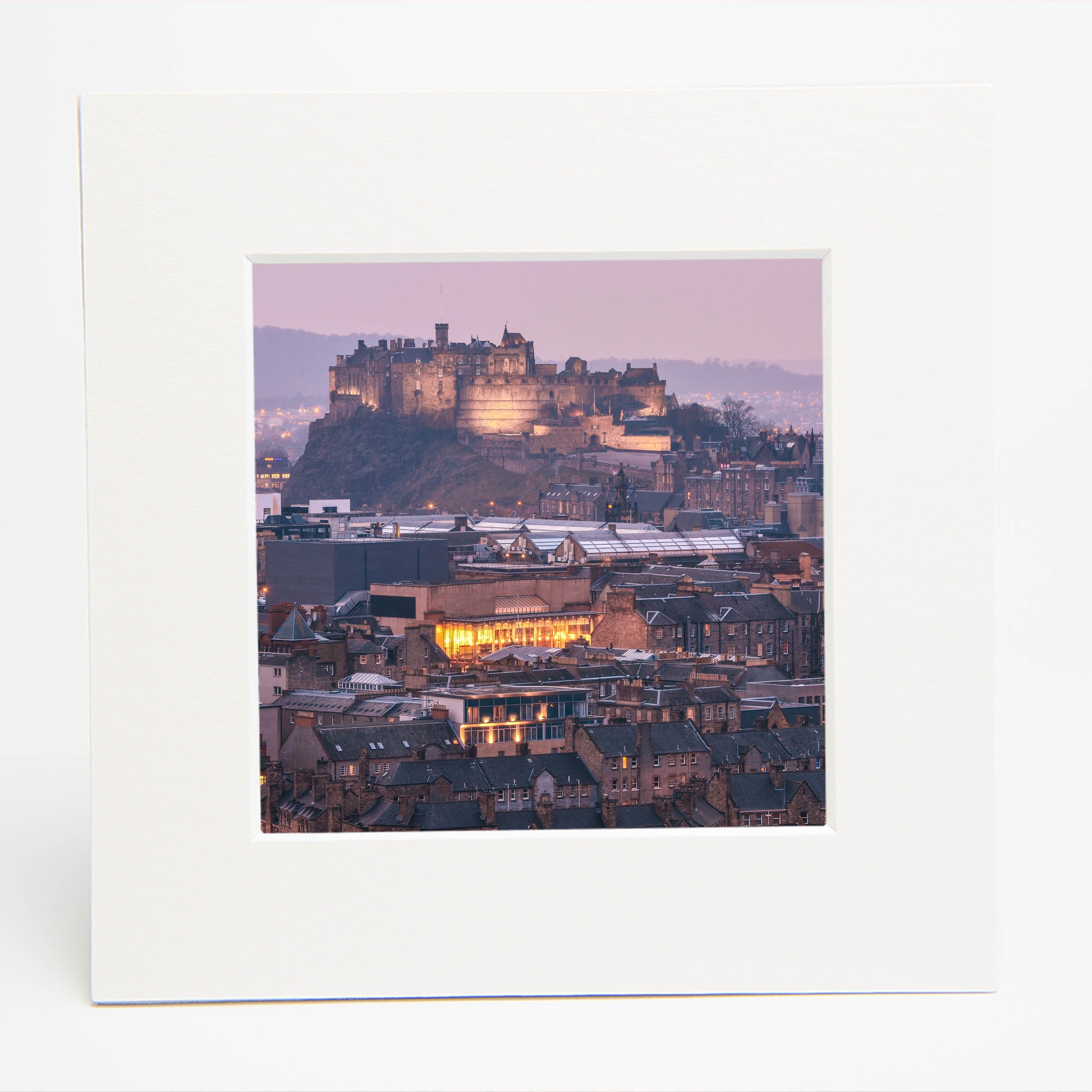 An image of Edinburgh Castle at dusk in a square white mount.