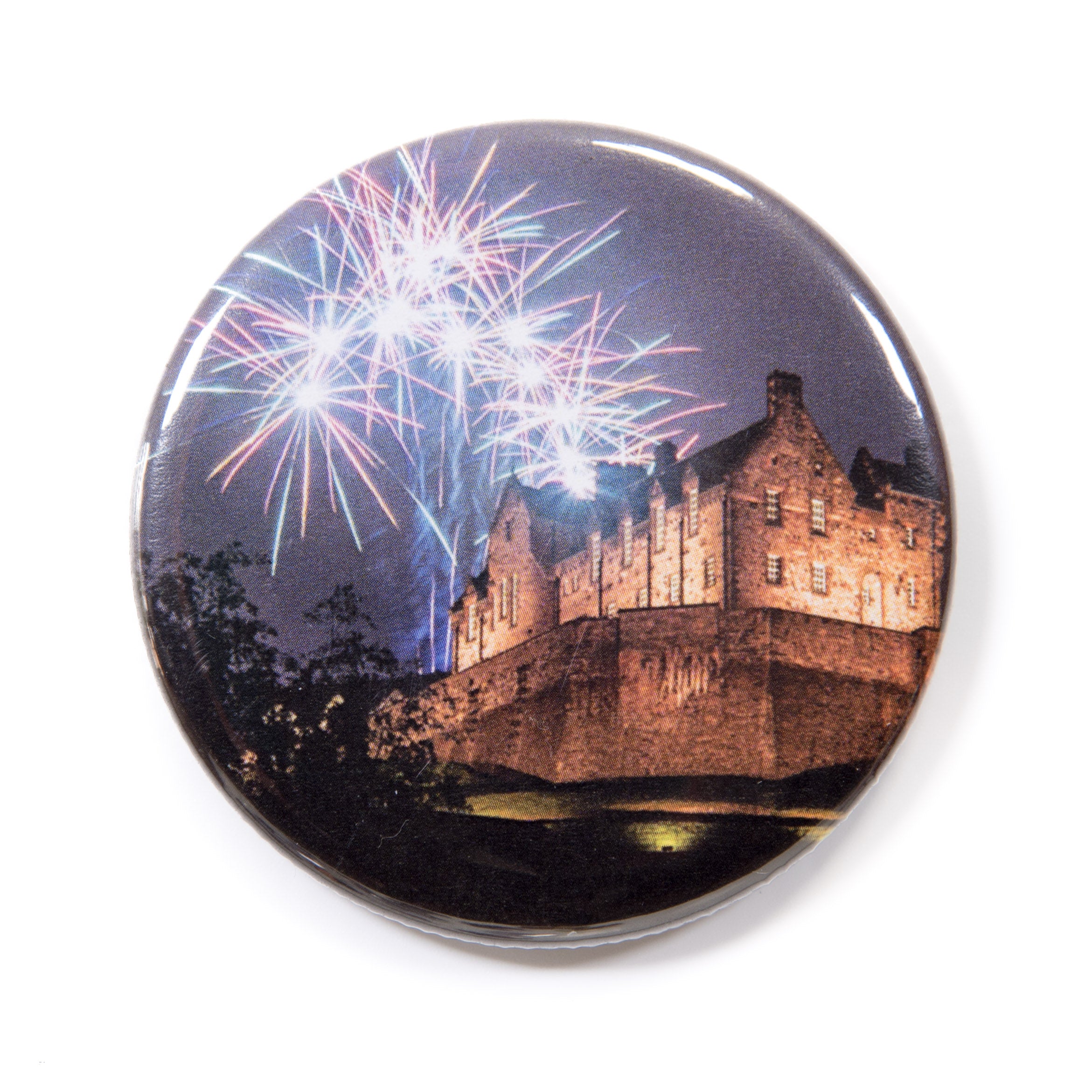 A round magnet with a Edinburgh Castle and fireworks design on a white background