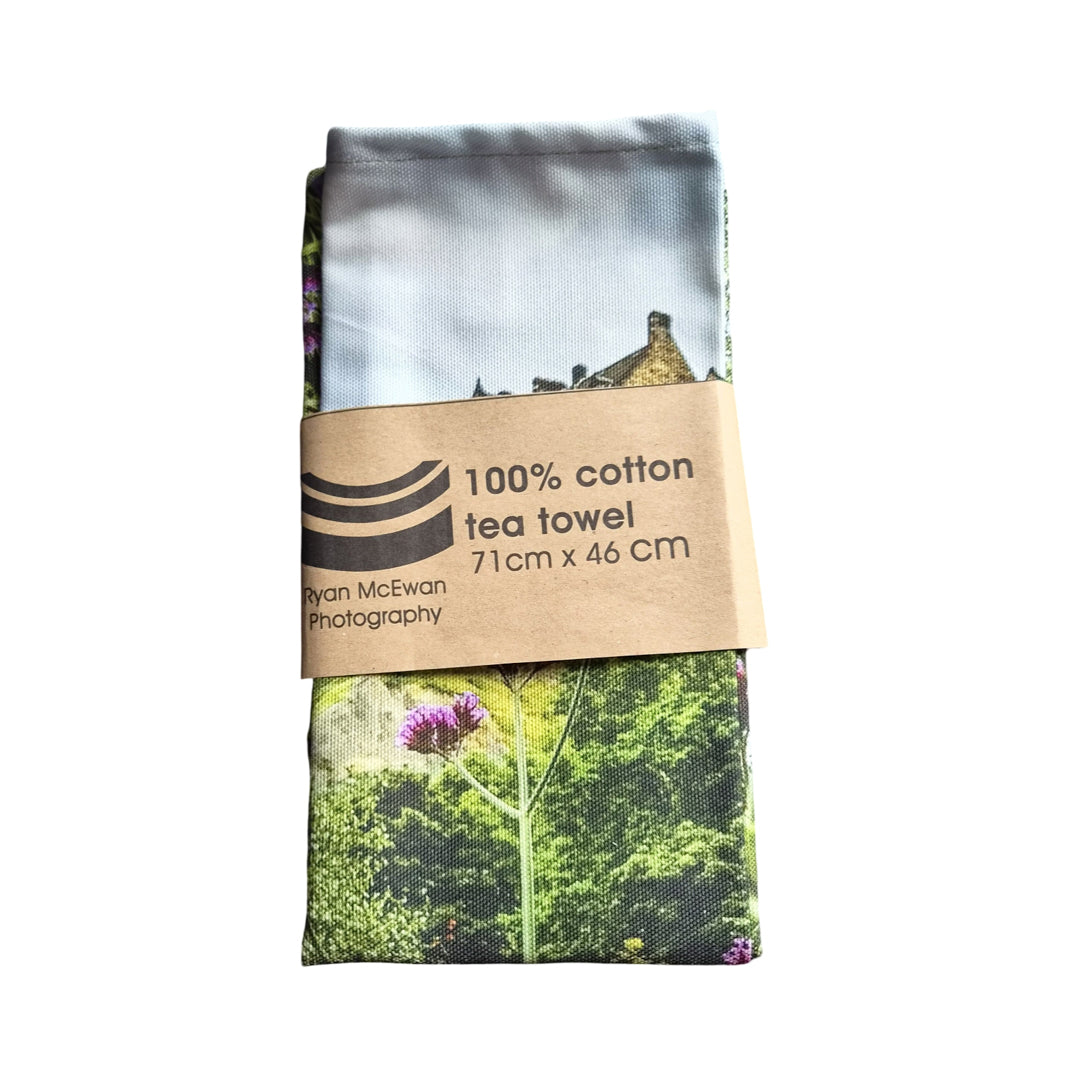 A tea towel wrapped in brown paper against a white background.