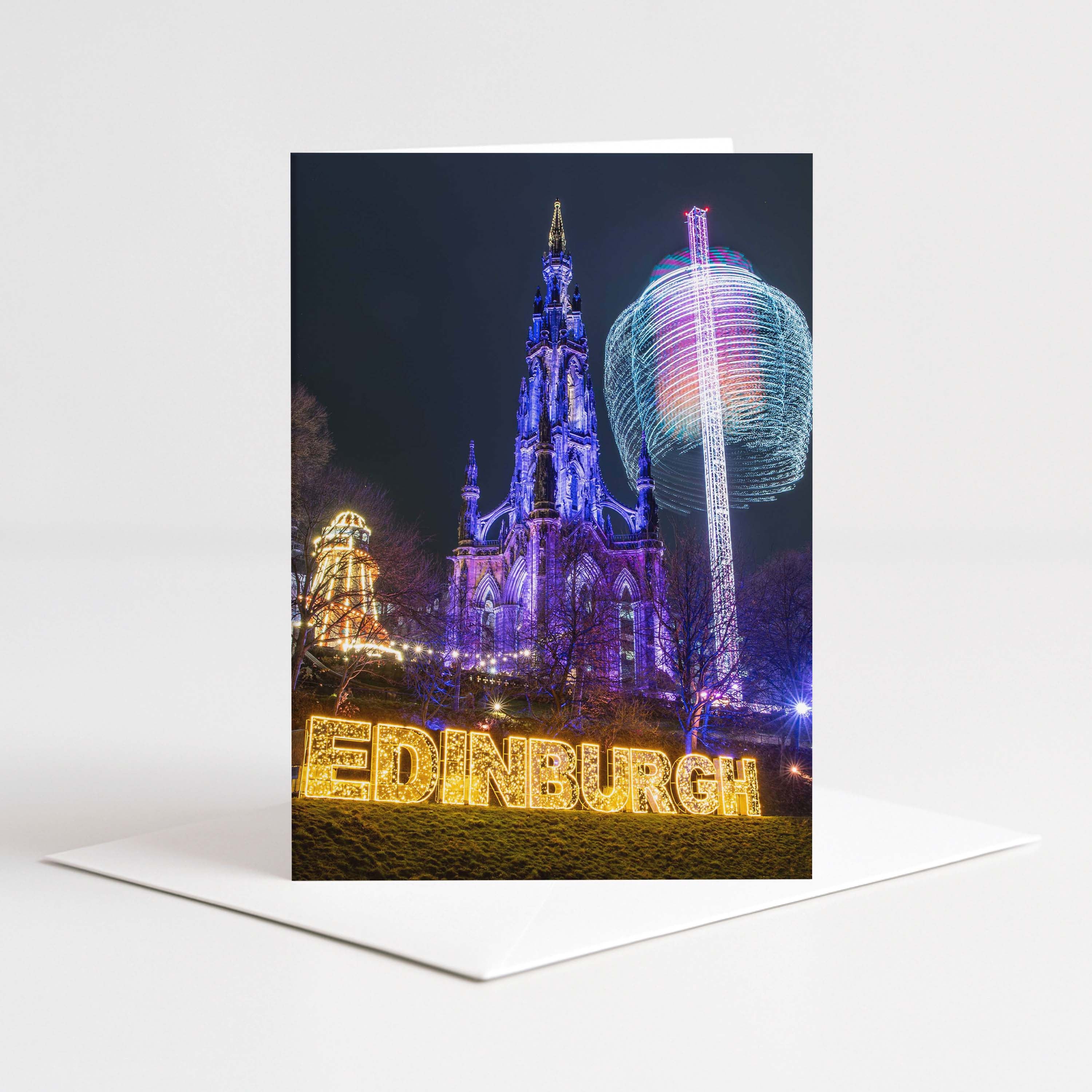 Decorative card with a festive Edinburgh scene featuring illuminated buildings and 'Edinburgh' text.
