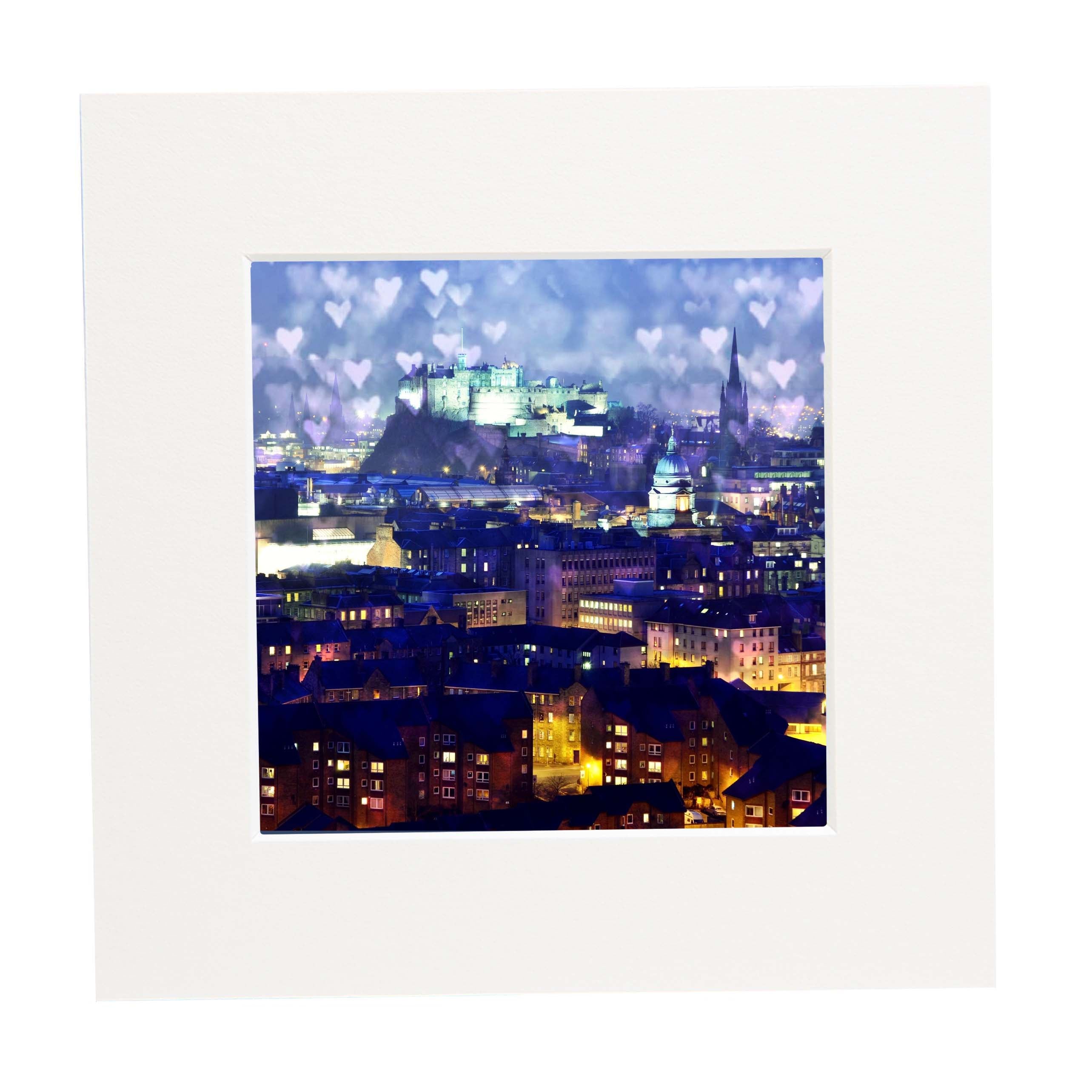 Cityscape at night with illuminated buildings and Edinburgh Castle with love hearts in the sky.