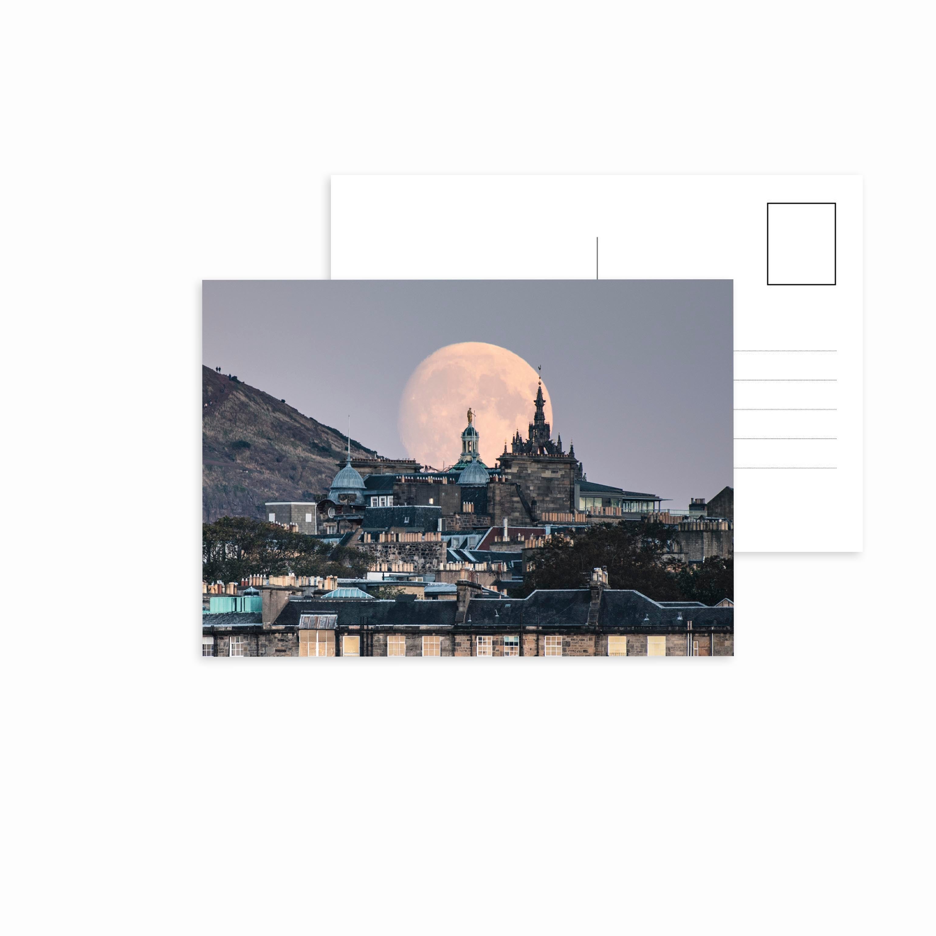 An image of moonrise in Edinburgh on a postcard.