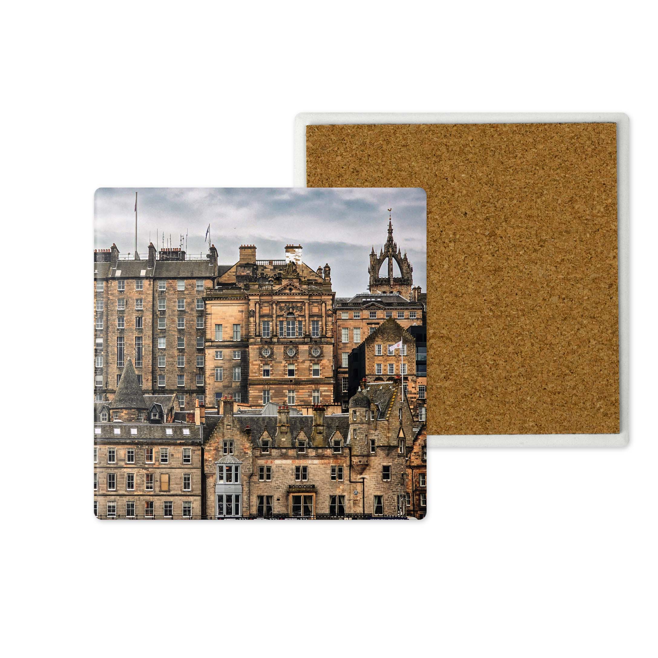 A square cork board or coaster shown from two angles on a white background. The front features a printed photograph of historic city buildings under a cloudy sky, while the back shows the natural brown cork texture.
