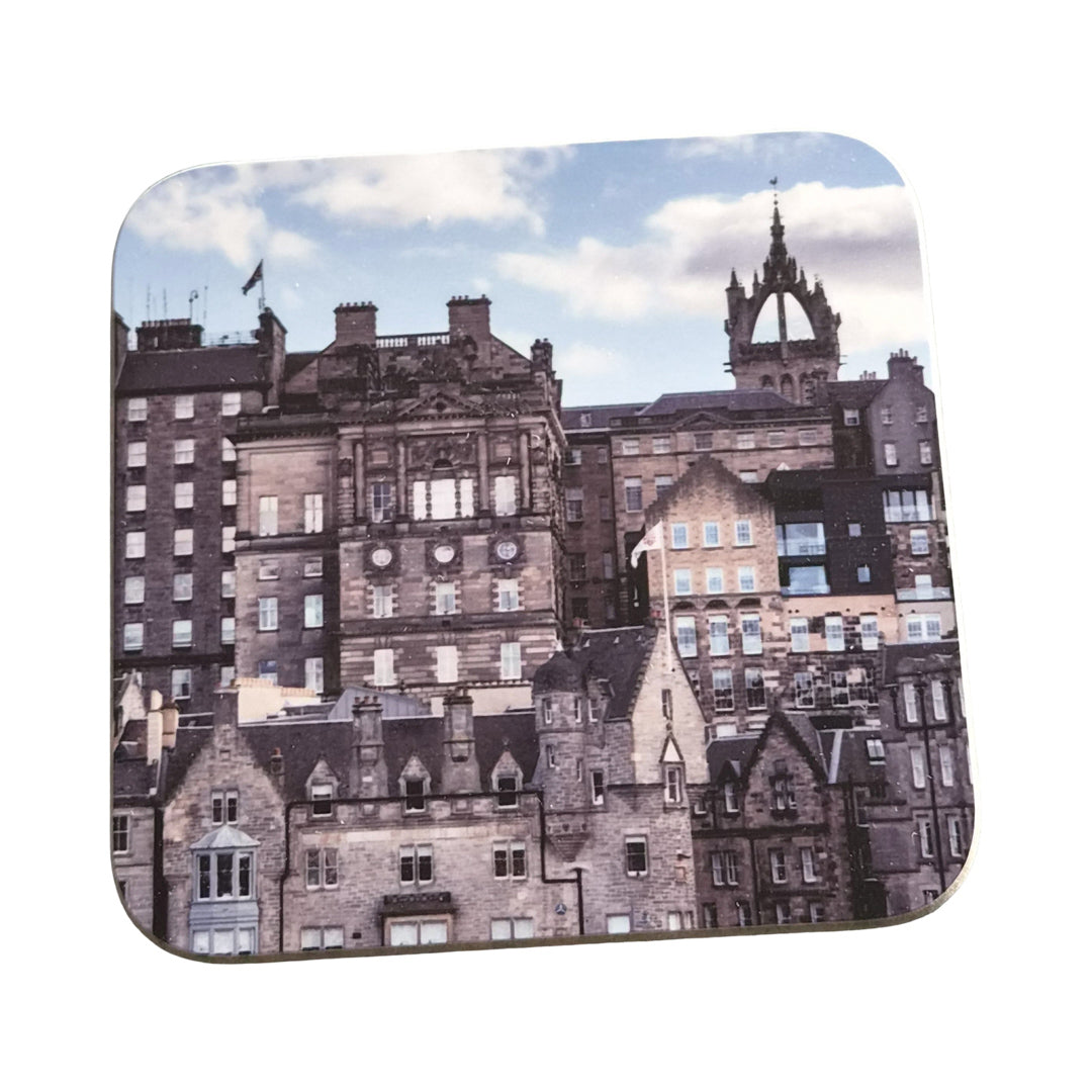 Old town Edinburgh buildings on a square wooden coaster against a white background.