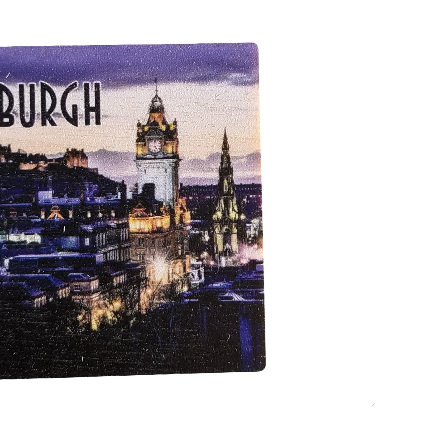 A wooden magnet featuring a picture of Edinburgh.