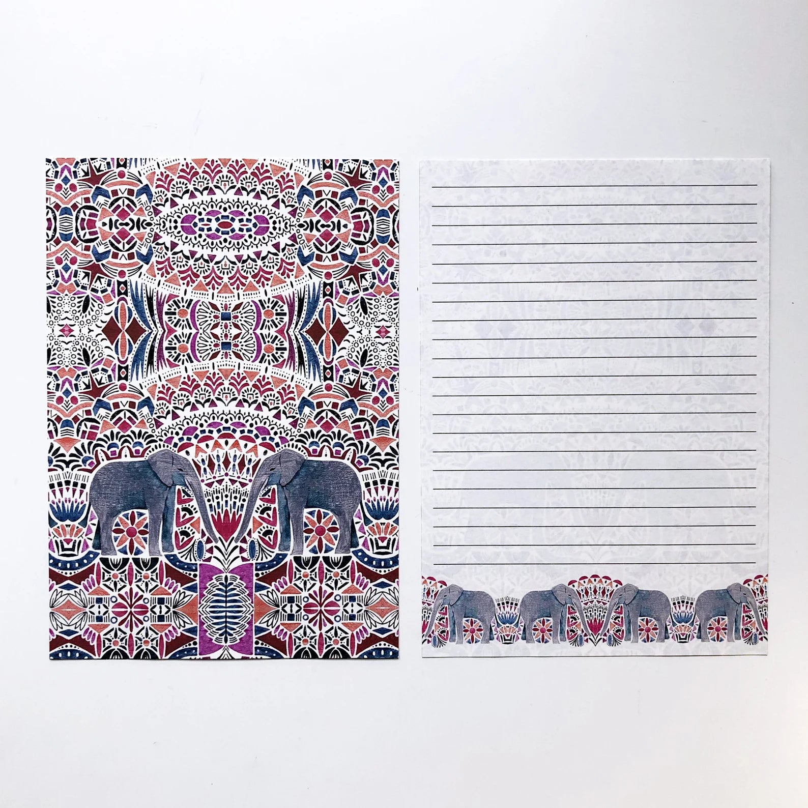 Notebook with patterned cover and lined pages on a white background.