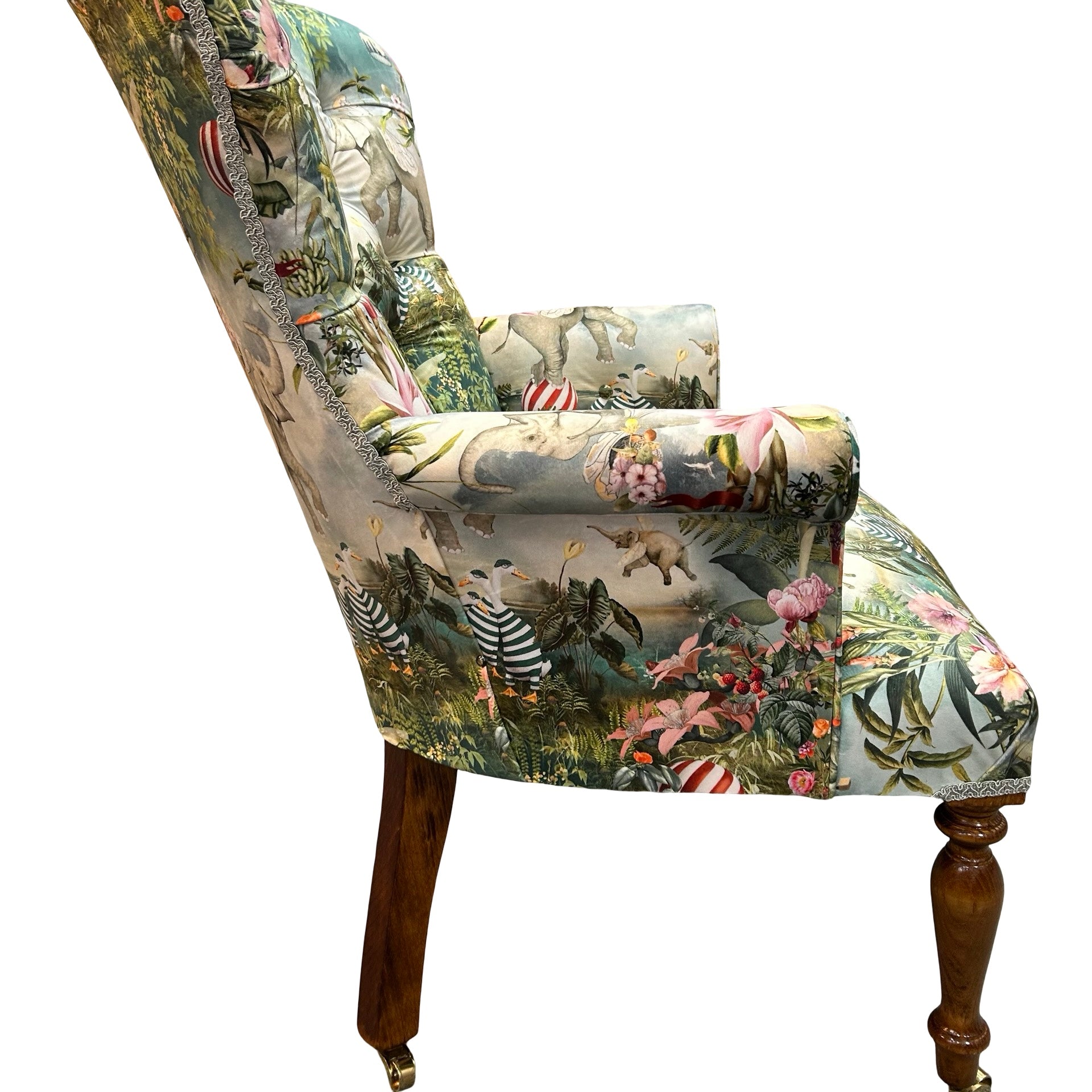 Decorative armchair with a colourful animal print on a white background.