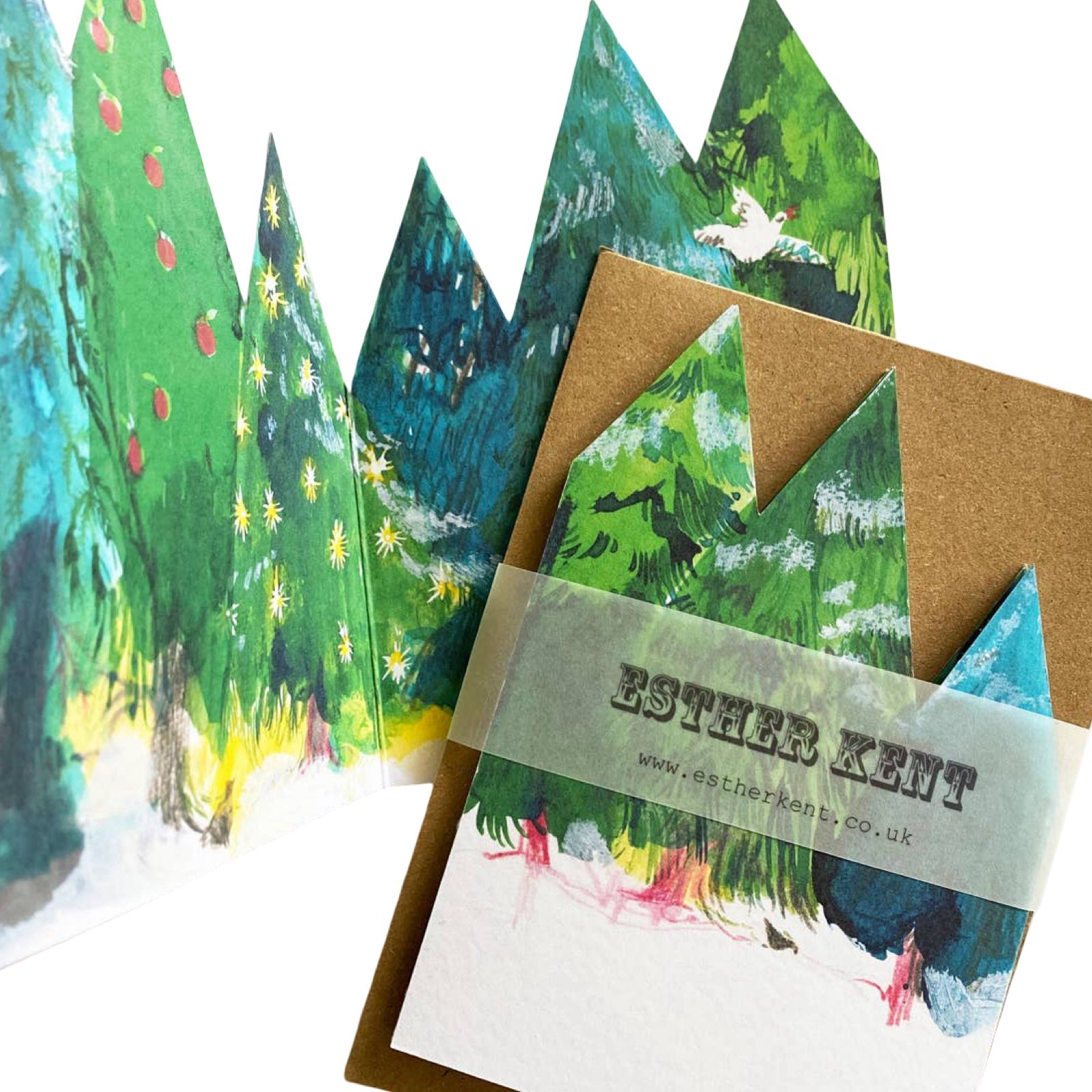 A concertina card open showing a forest with trees in shades of green and snow on the ground.