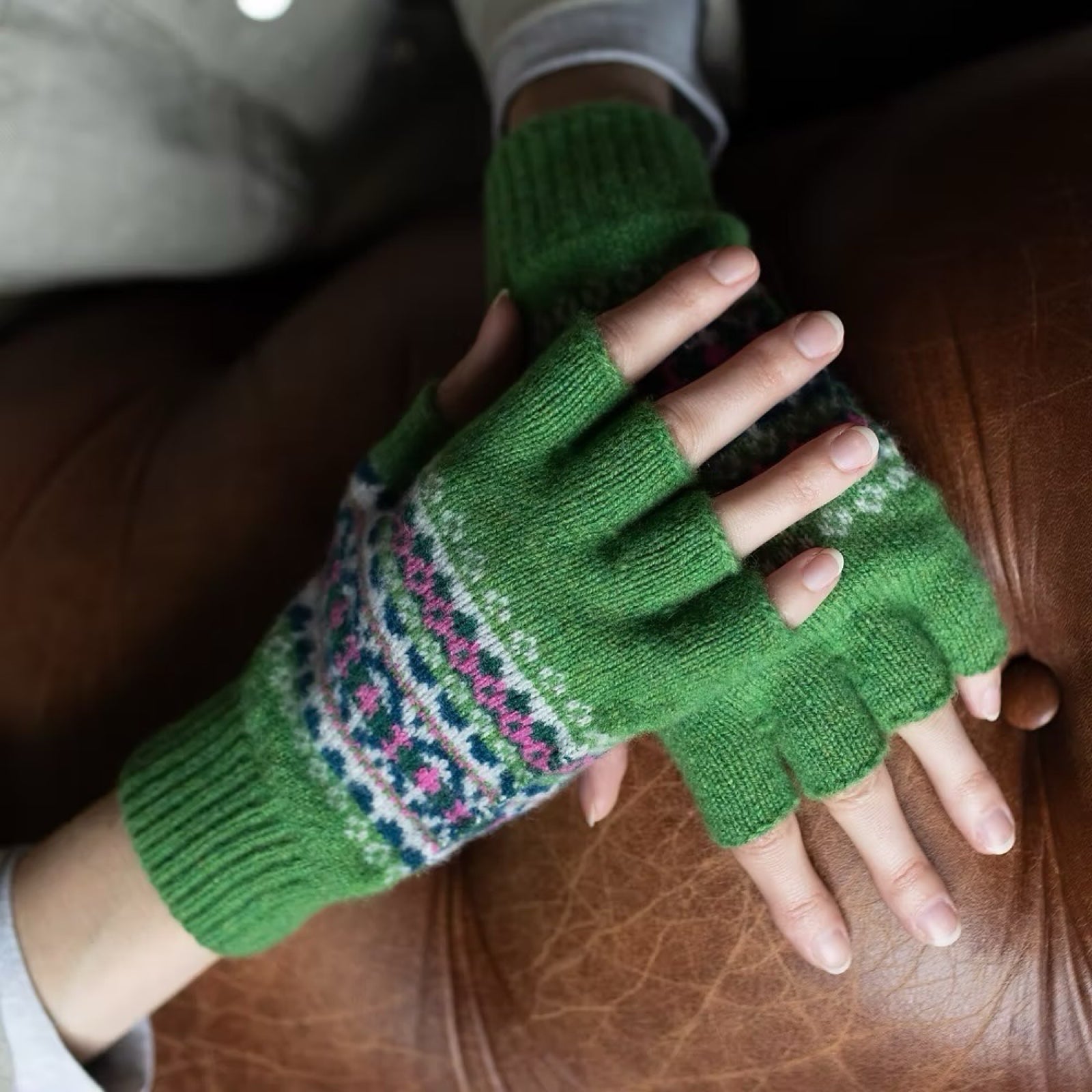Ladies' green fingerless gloves with a contemporary pattern in pink, navy and white.