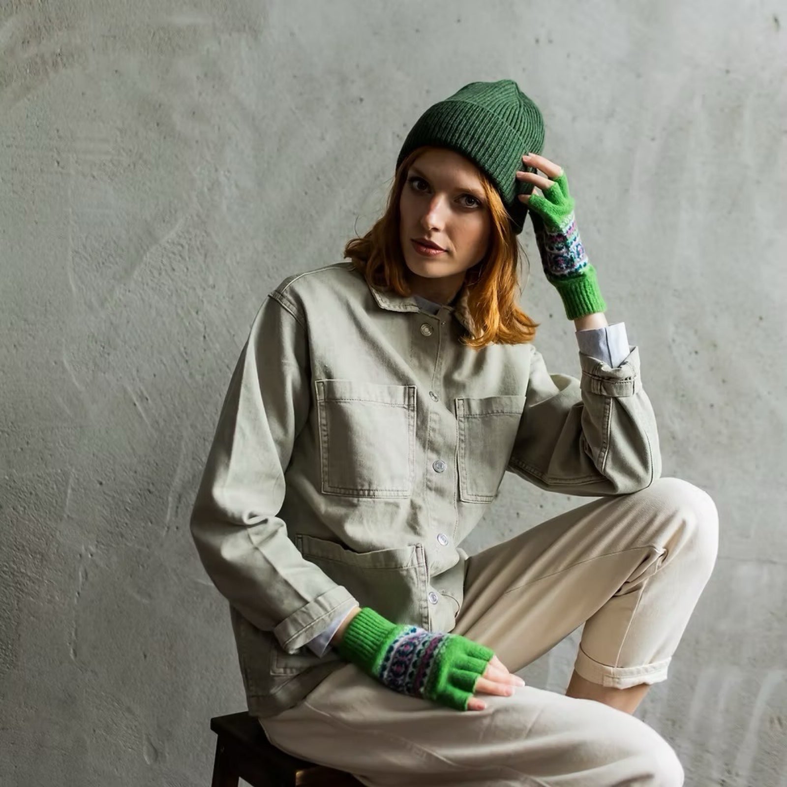 Ladies' green fingerless gloves with a contemporary pattern in pink, navy and white.