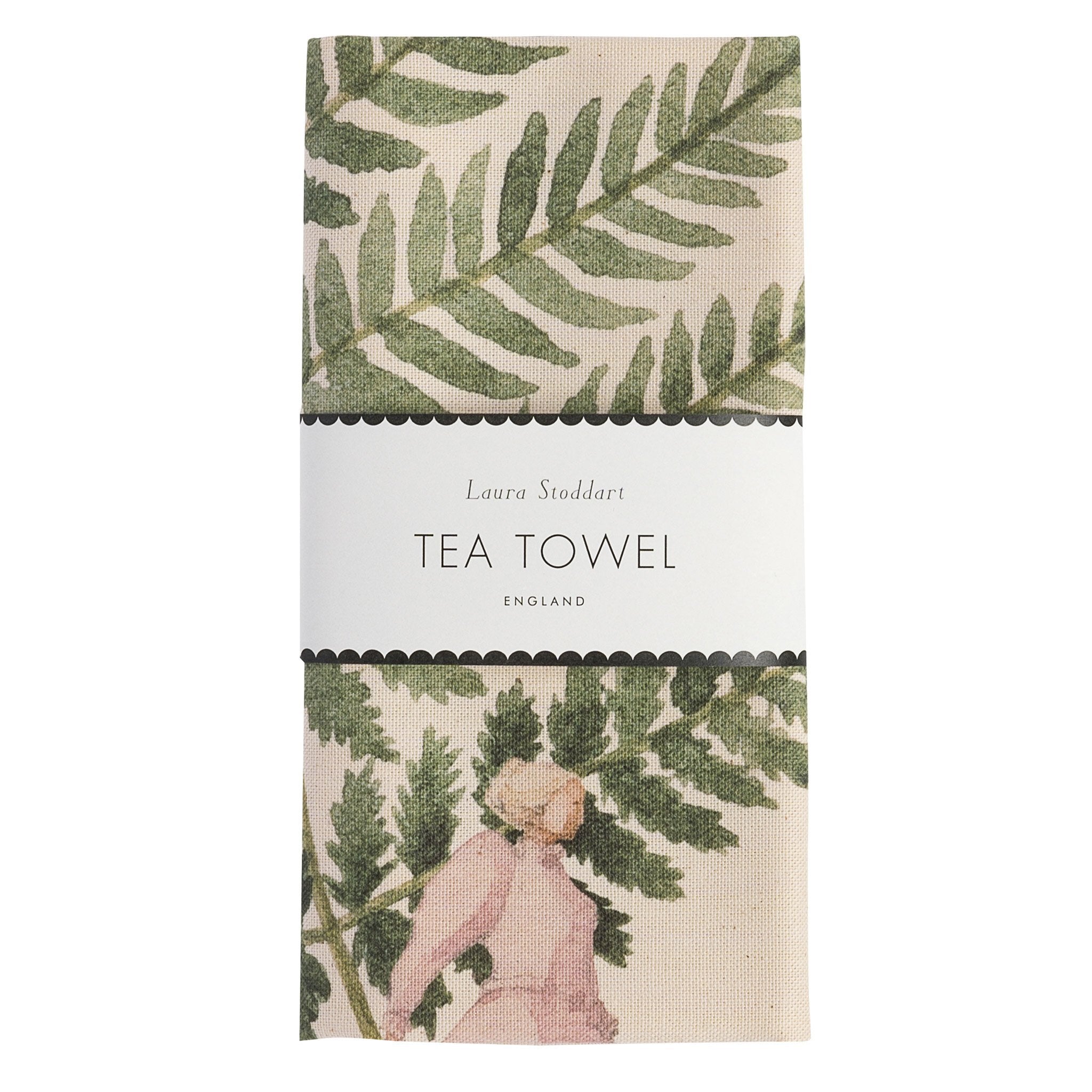 A folded tea towel featuring an illustration of a lady holding a giant fern leaf.