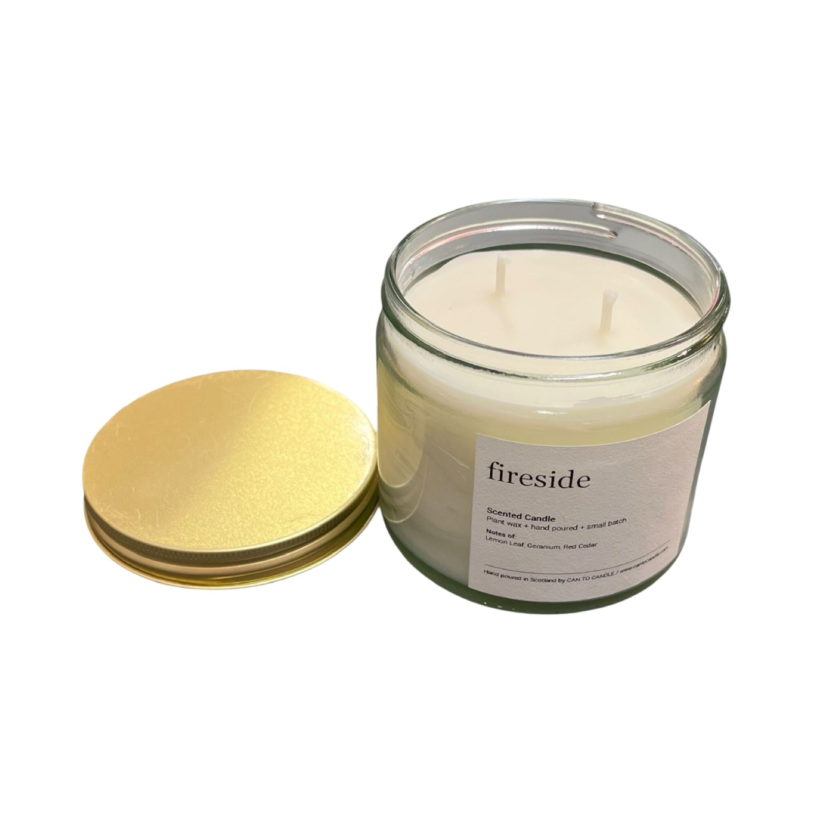 Glass candle with a gold lid on a white background.