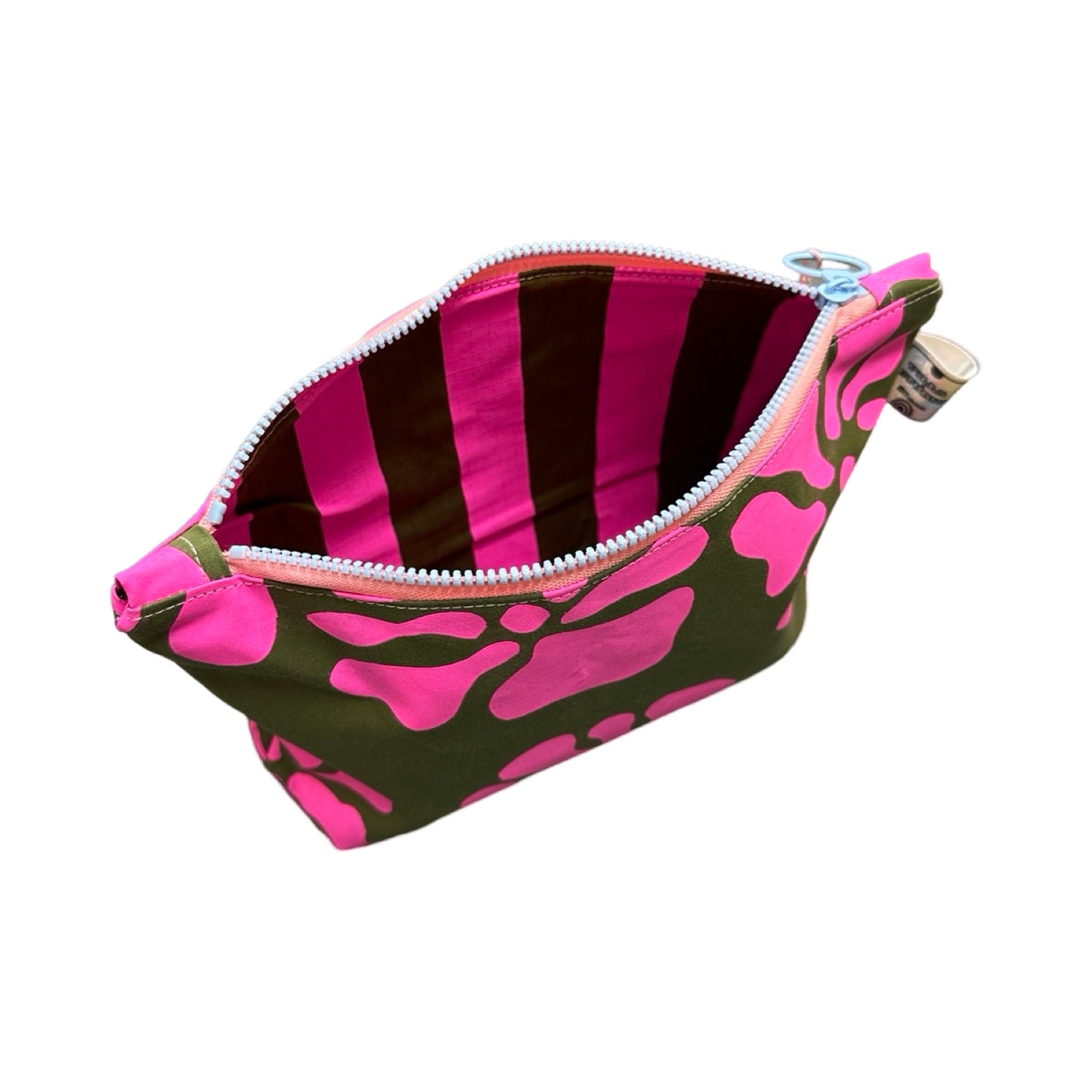 A grey canvas cosmetic bag with neon pink flowers with pink and grey striped lining.
