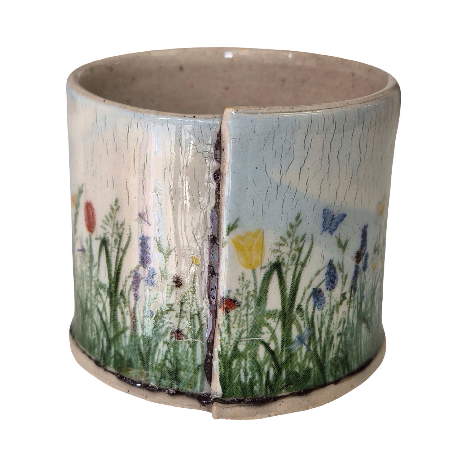 Ceramic planter with floral design on a white background.