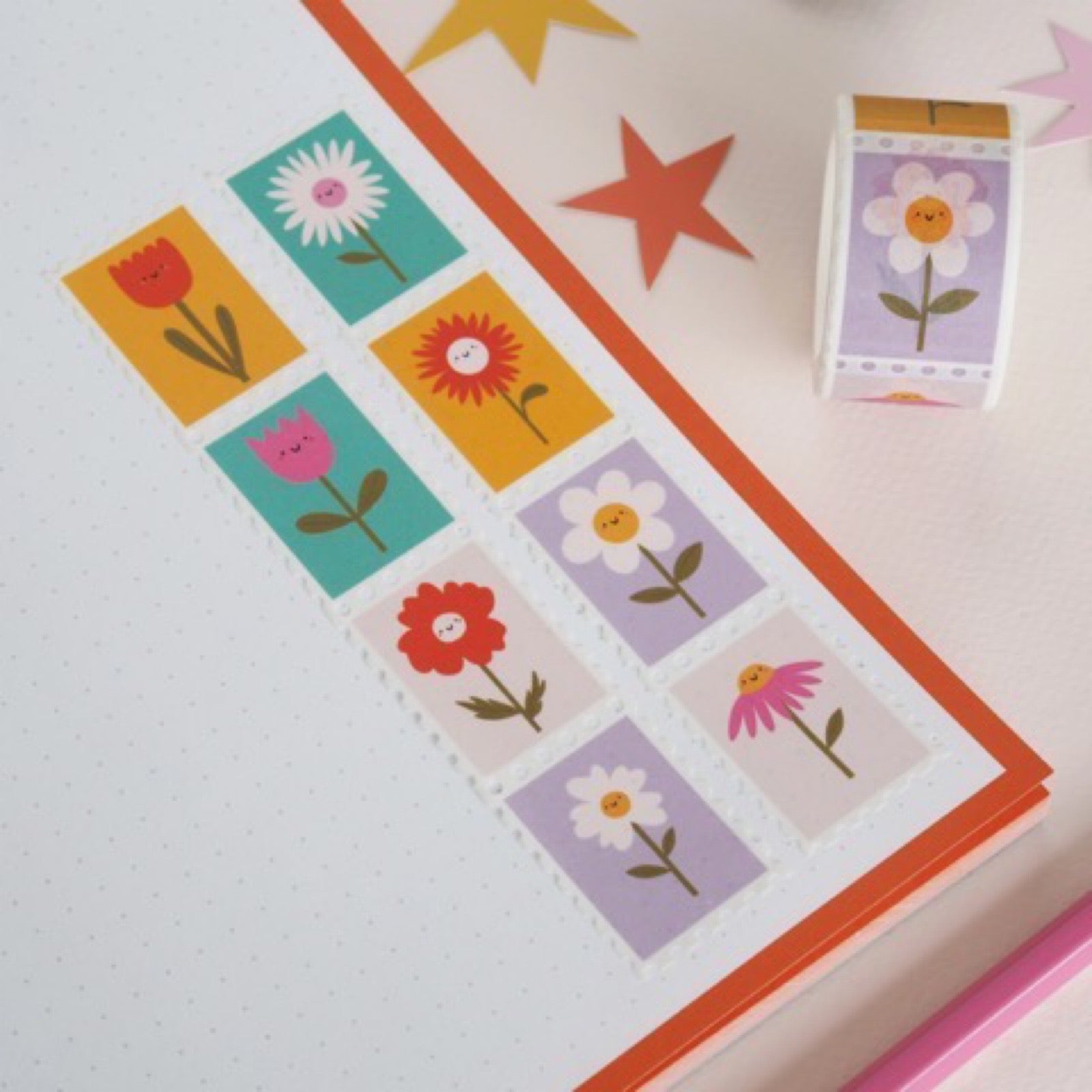 Rolls of washi tape with colourful flowers in the design of stamps.
