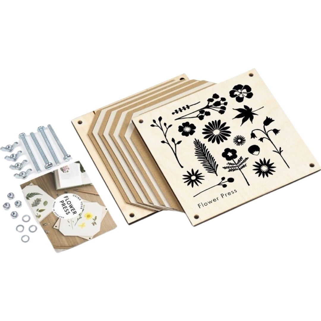 All the components of a square flower press, wooden front and back, card, sugar paper and nuts and bolts.