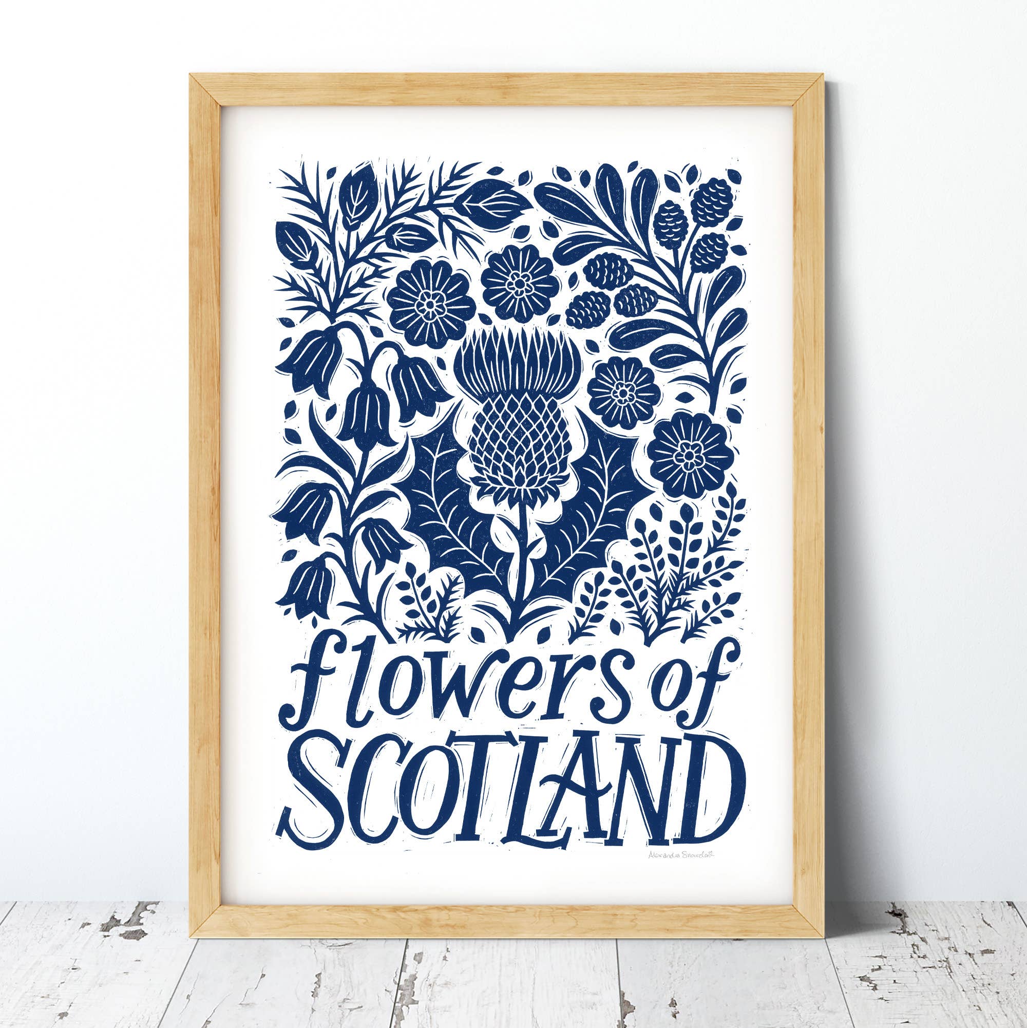 Framed artwork with blue floral design and 'Flowers of Scotland' text on a white background.