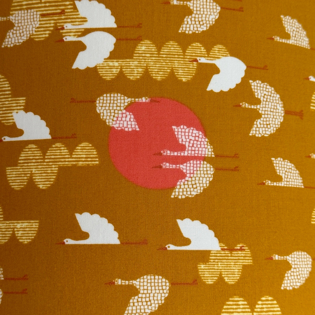 Mustard cotton fabric with white birds and pink moons