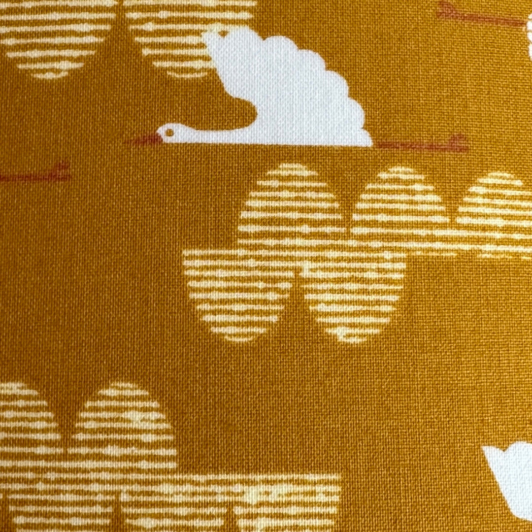 Mustard cotton fabric with white birds and pink moons