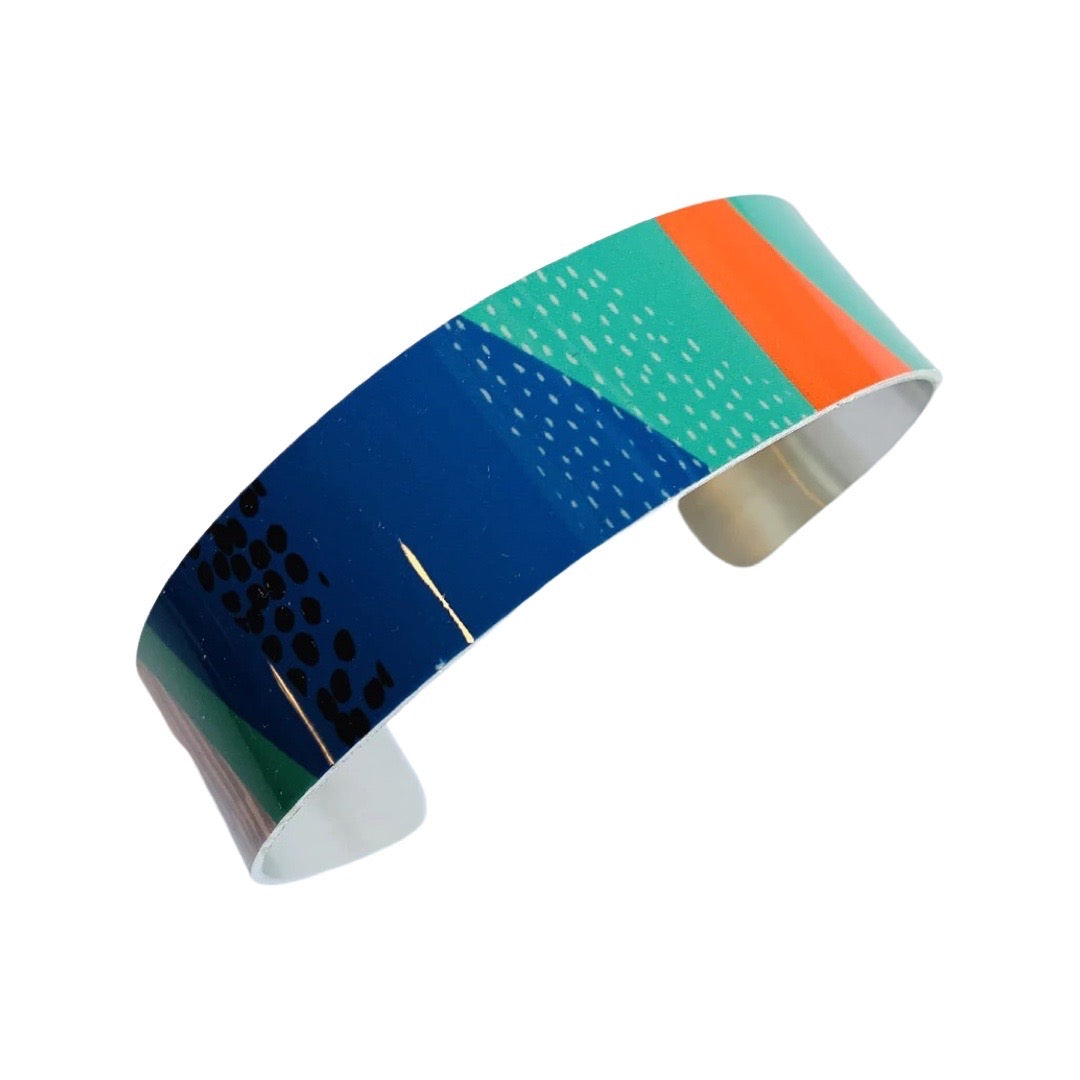 Colourful bracelet with geometric patterns on a white background.