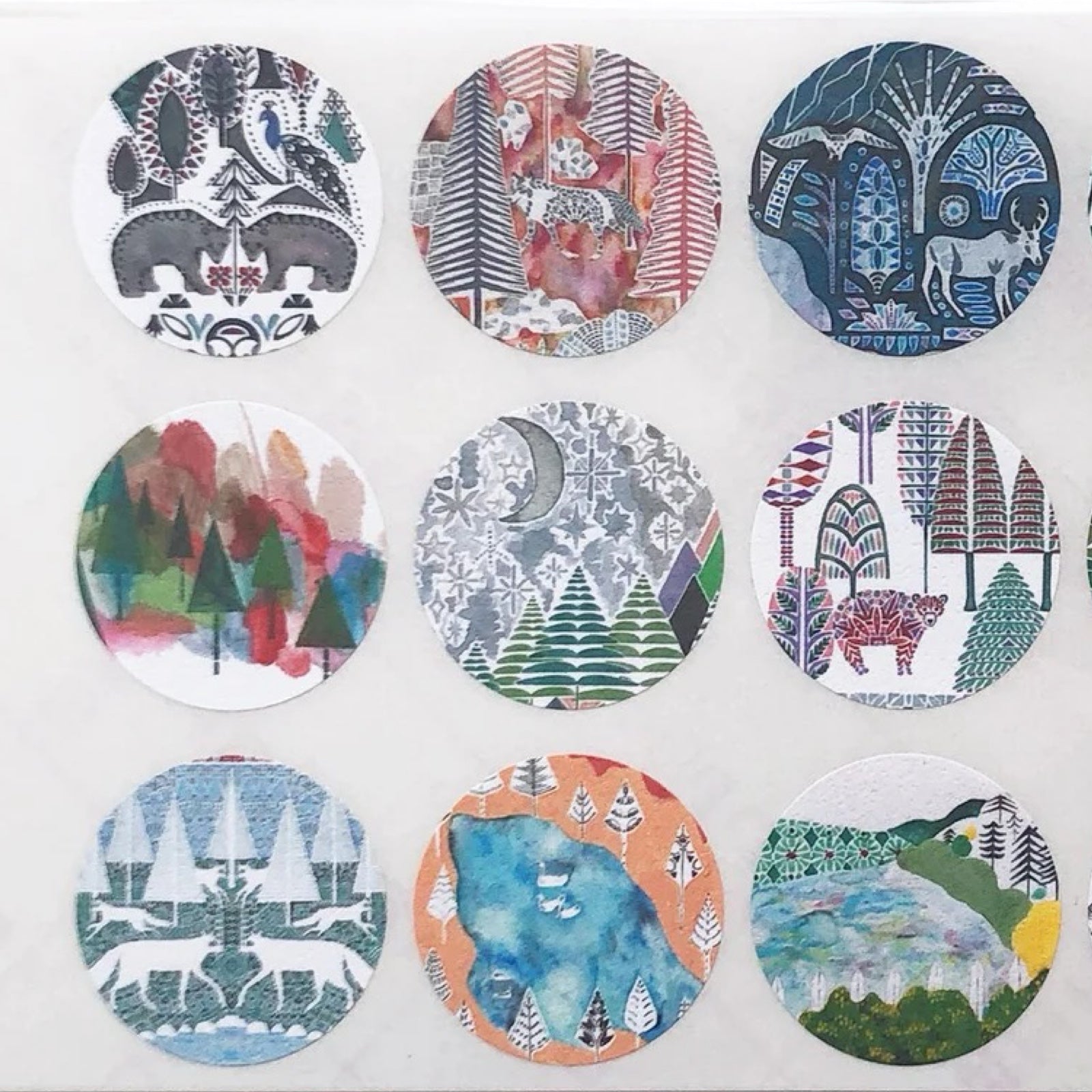 Set of circular stickers with nature-themed designs on a white background.