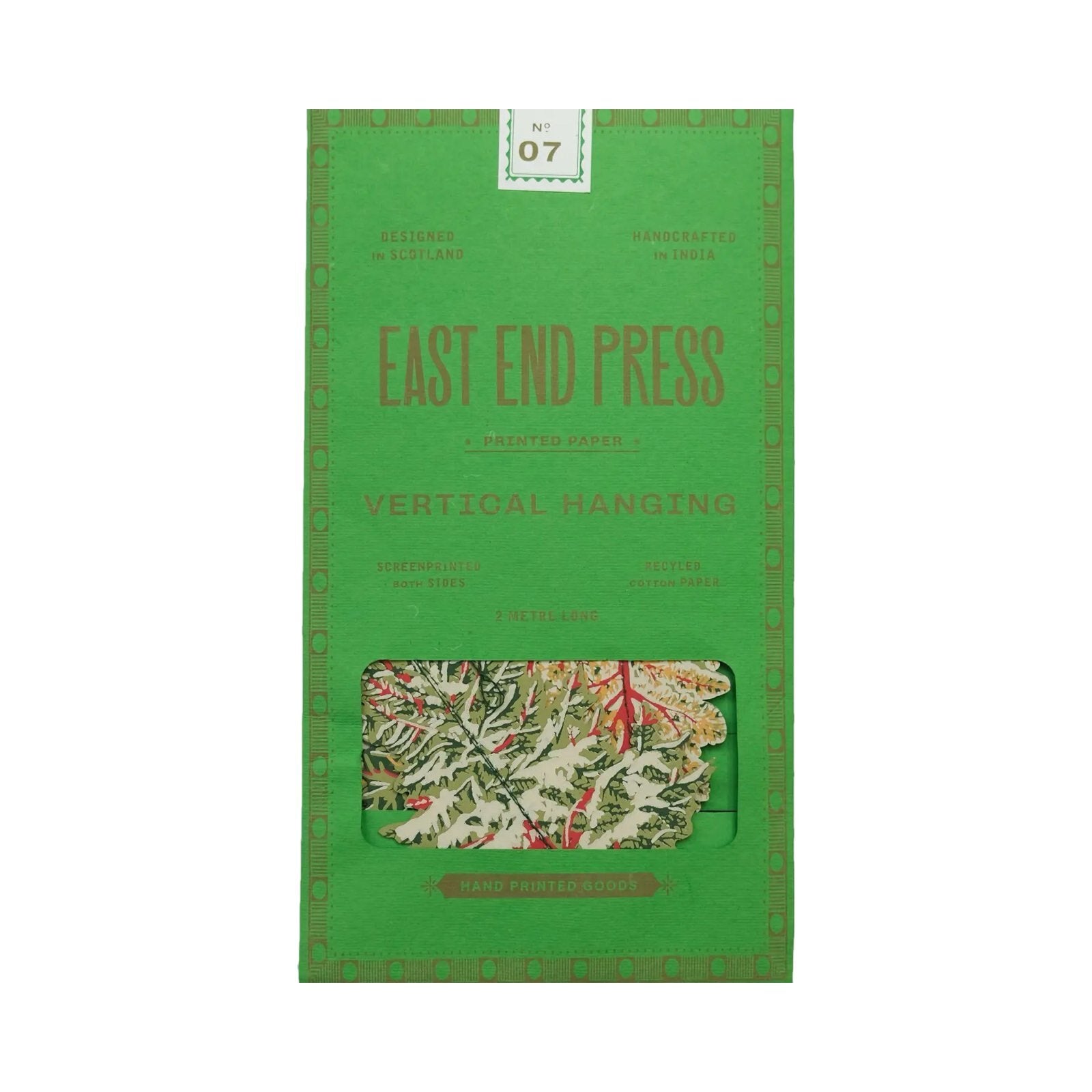 A green paper packet with a forest vertical garland inside.