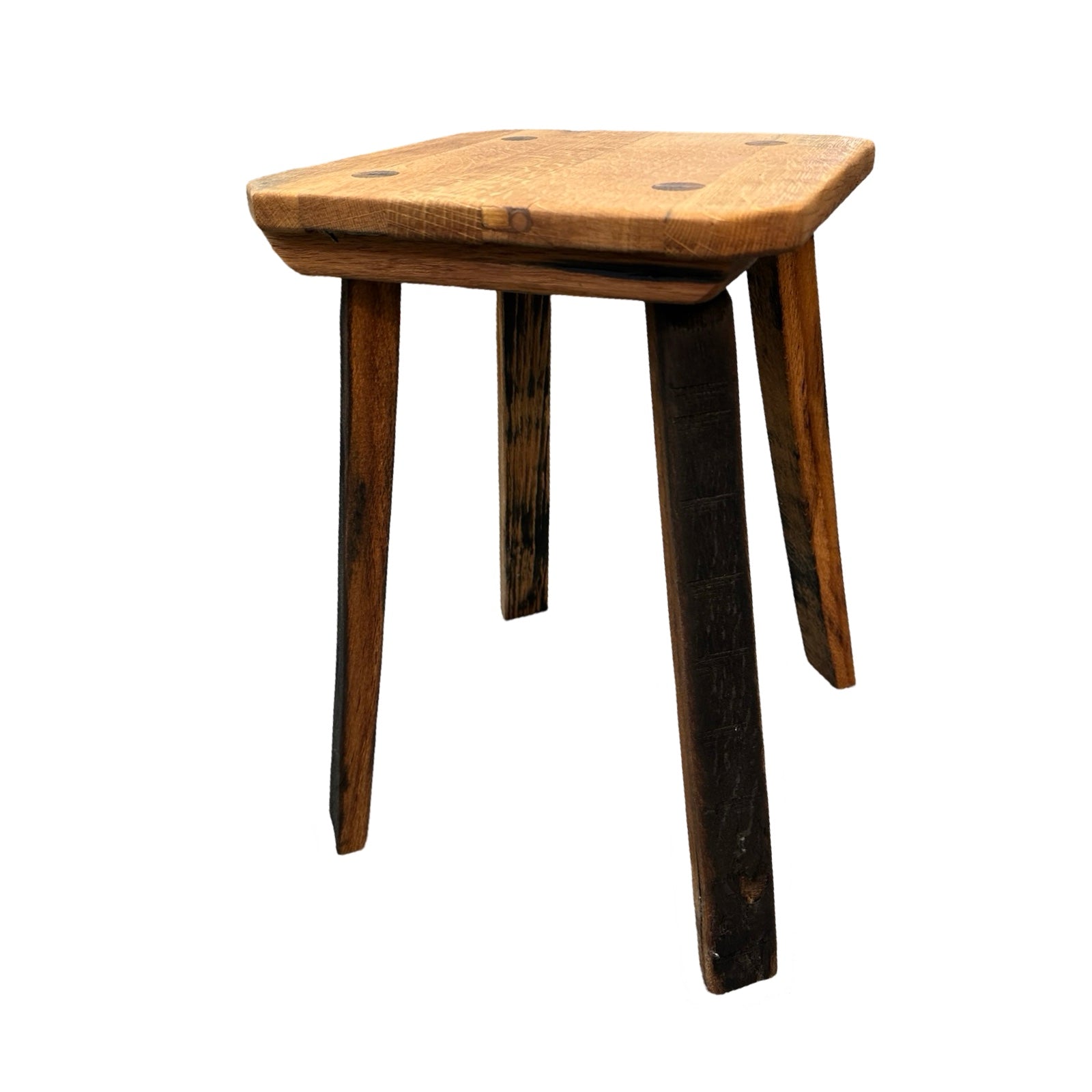 The legs of a wooden stool made form whisky barrels.