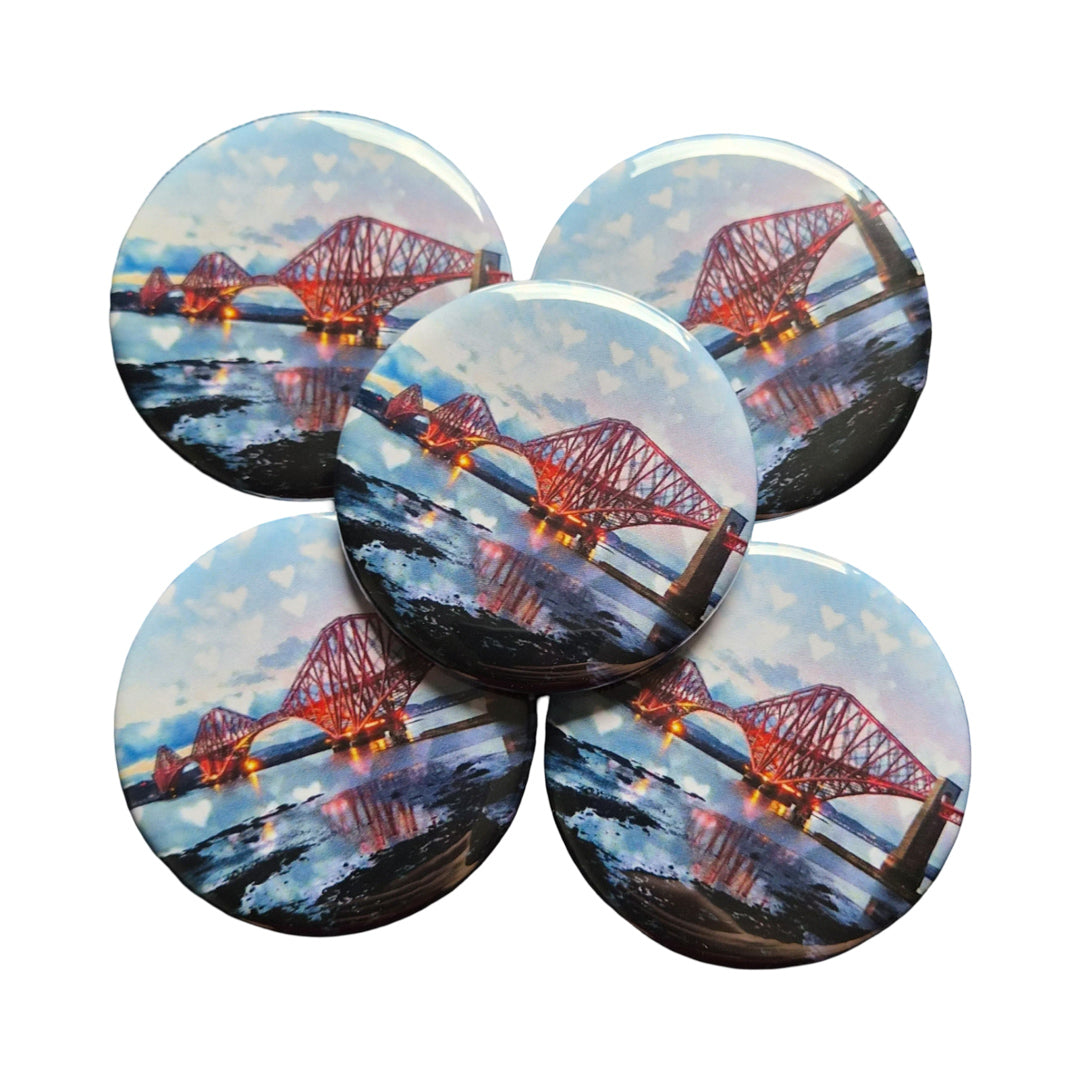 A group of round magnets with a picture of the Forth Bridge on them.