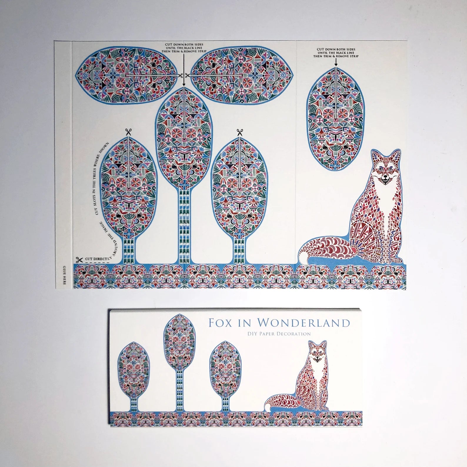 Decorative paper with a fox and floral trees design on a white background.