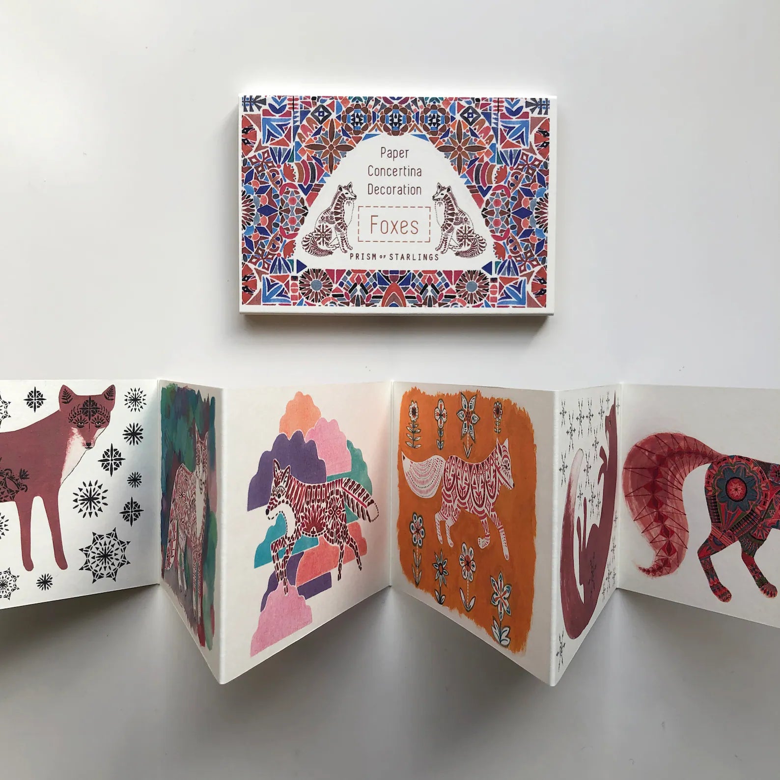 Open card with fox illustrations on a white background.