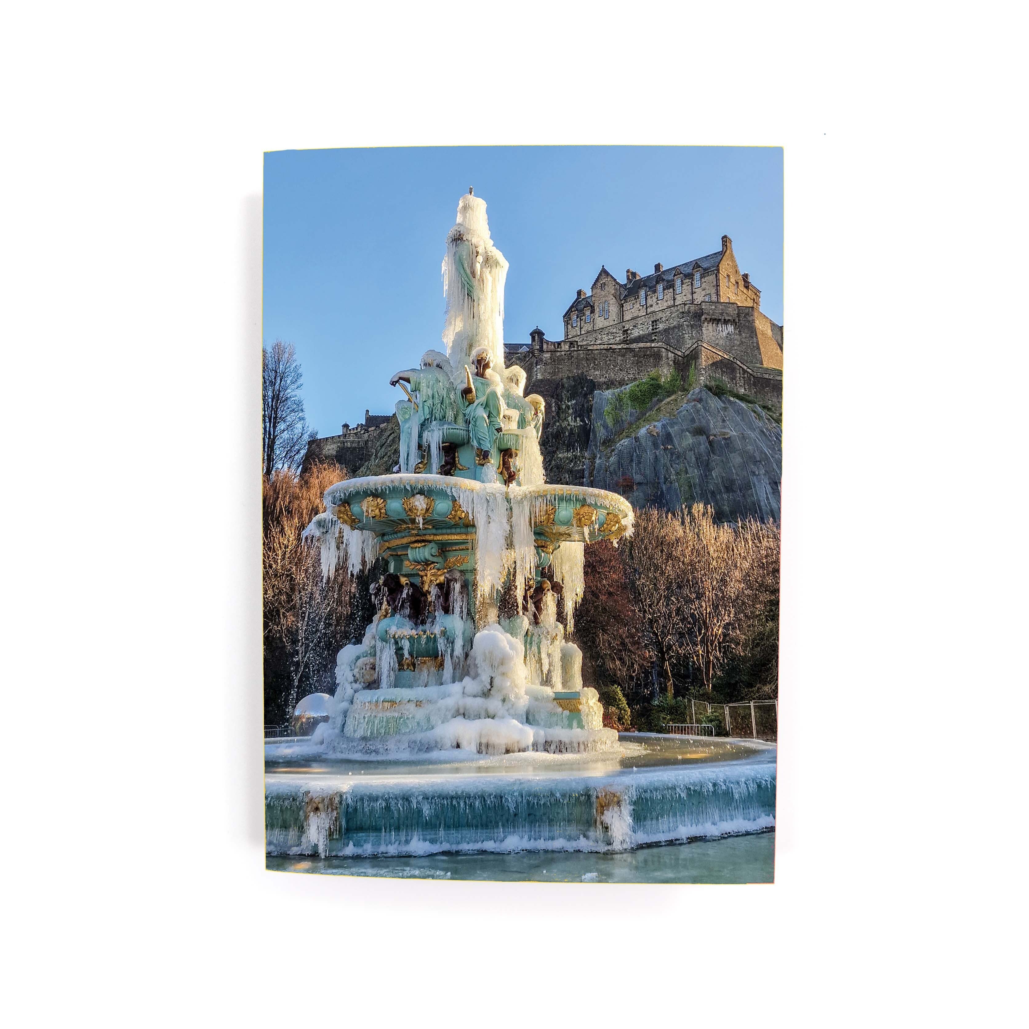A greeting card featuring a frozen Ross Fountain with Edinburgh Castle in the background.
