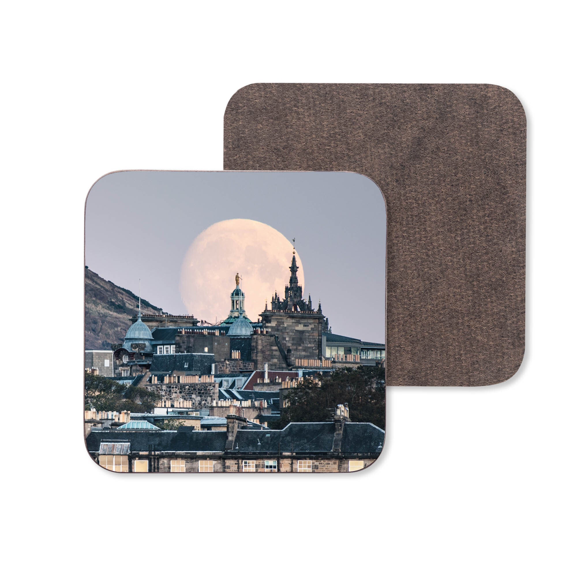 An image of the Edinburgh skyline with a full moon rising on a wooden coaster.